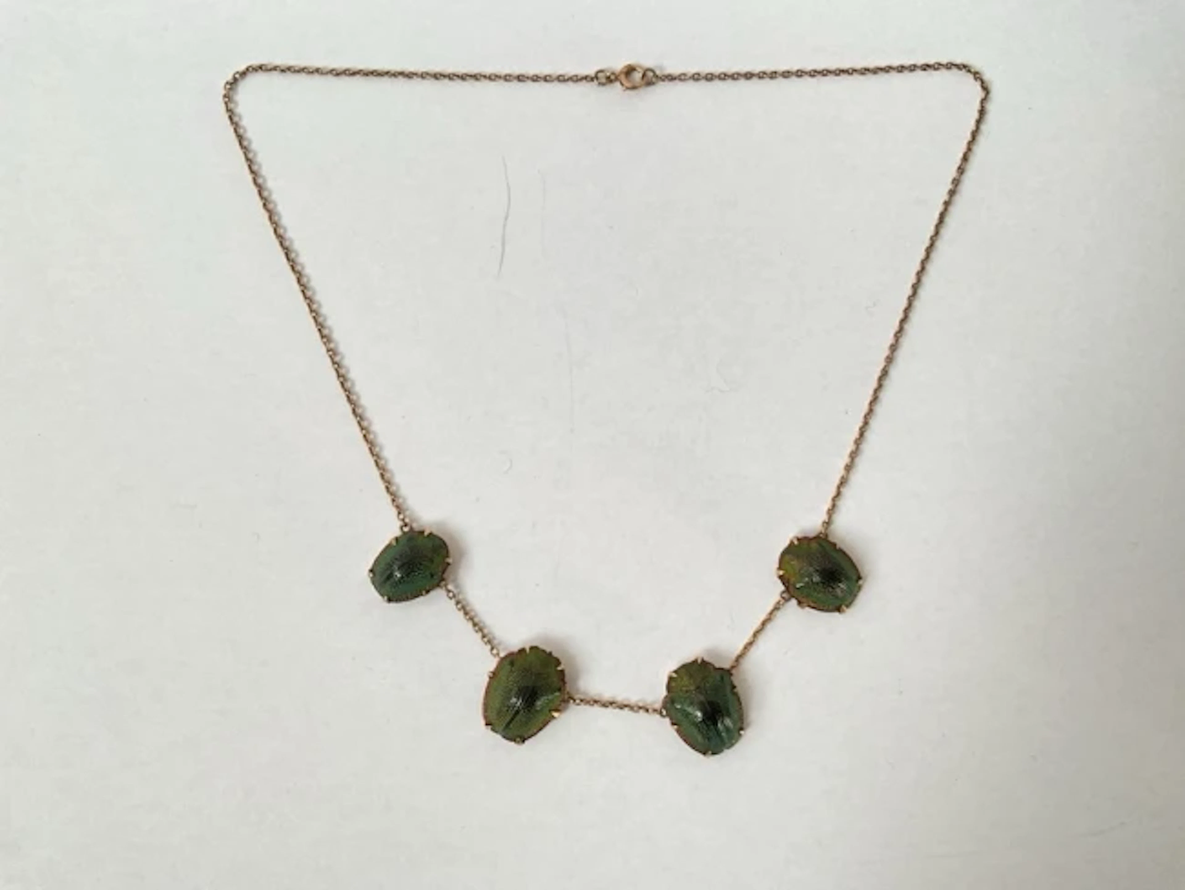 An antique unmarked gold scarab shell necklace, the four casings claw