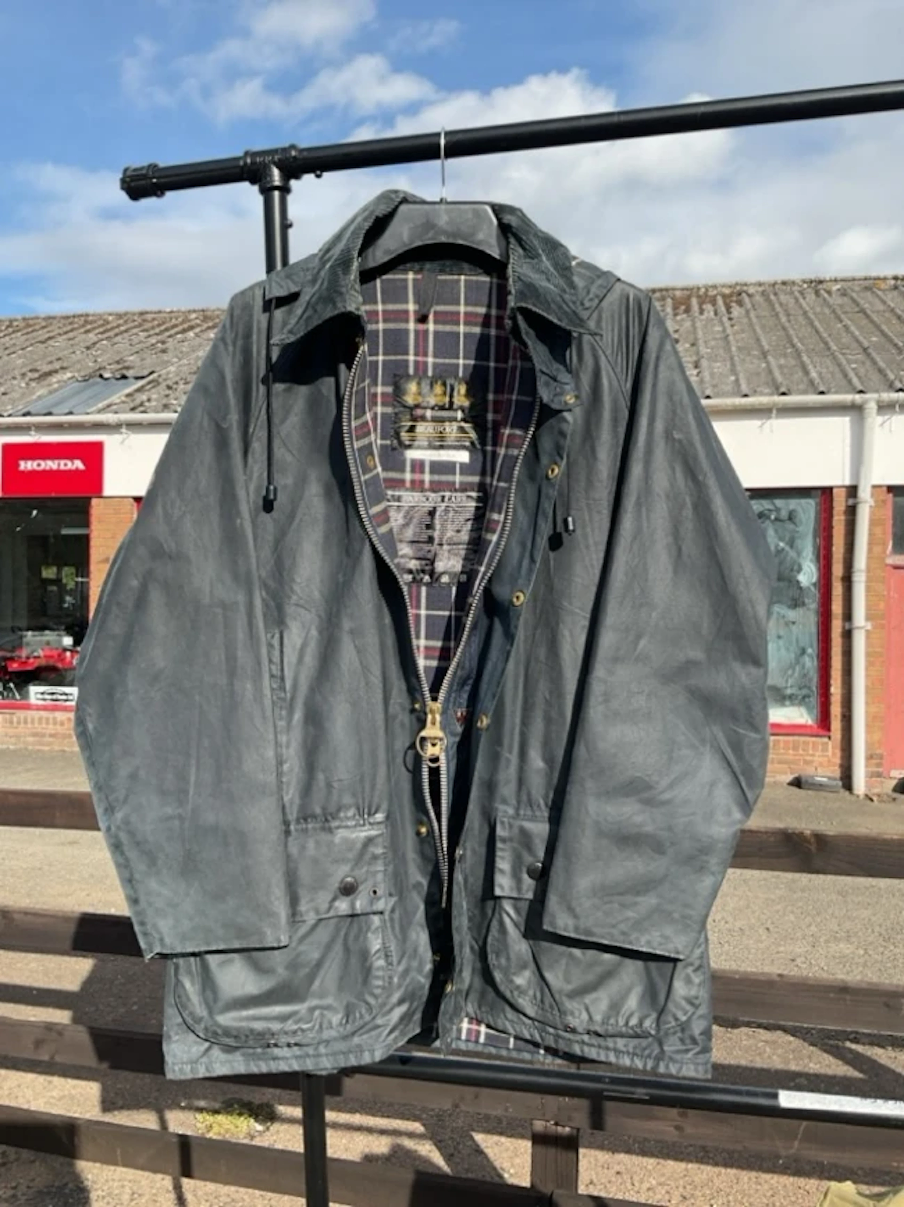 A “nearly new” Barbour navy Beaufort jacket with detachable hood - medium.