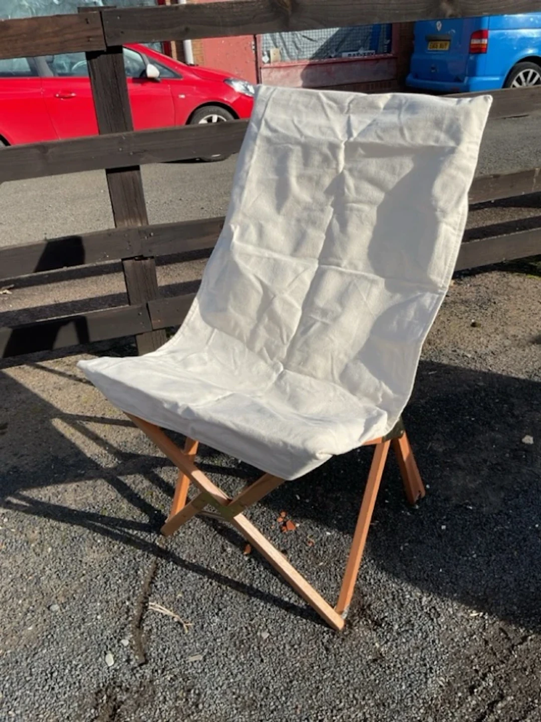 A folding canvas covered chair with hardwood folding frame - in hold-all bag.