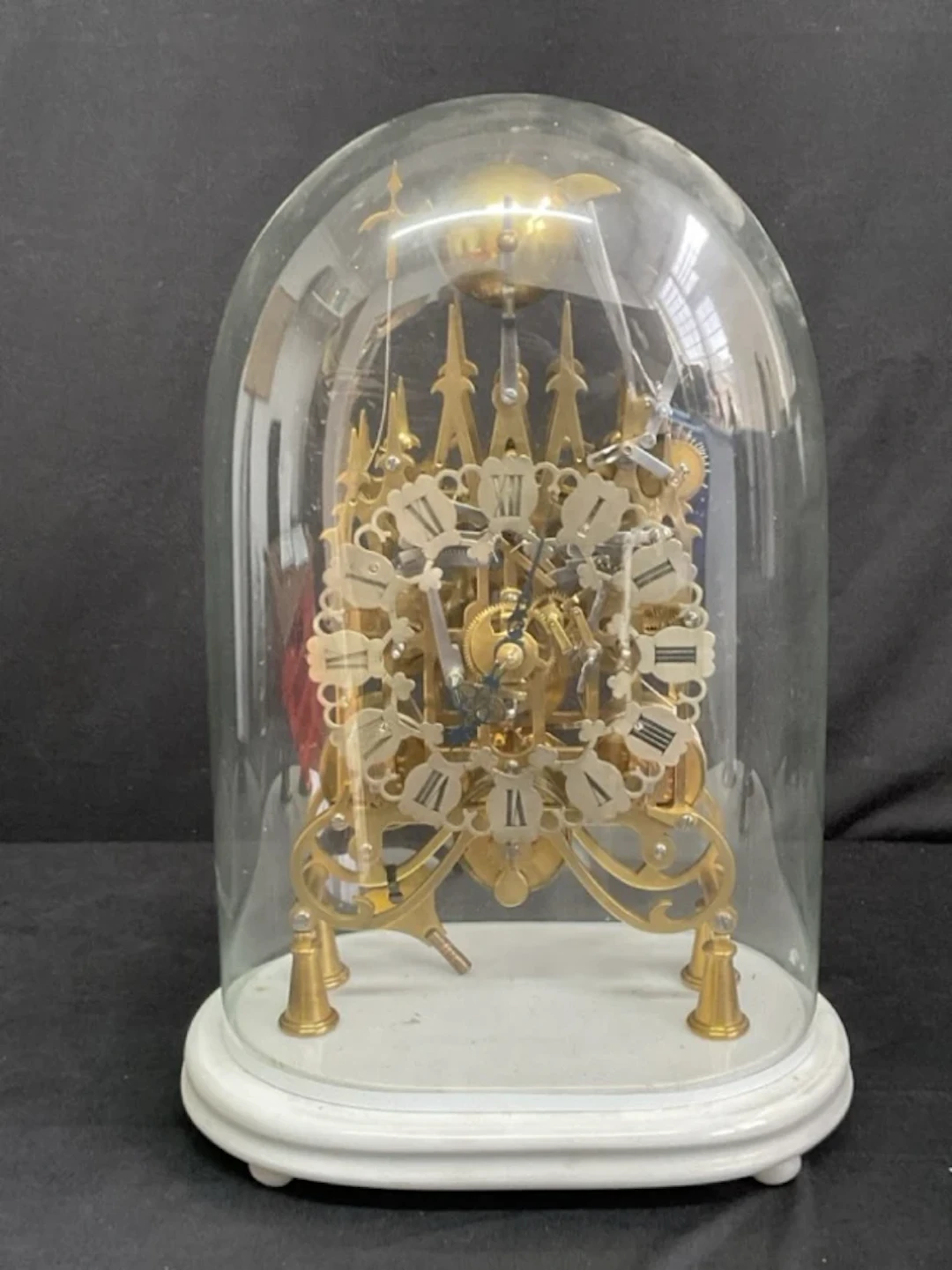 A C19th English glass domed brass triple fusée gothic skeleton clock