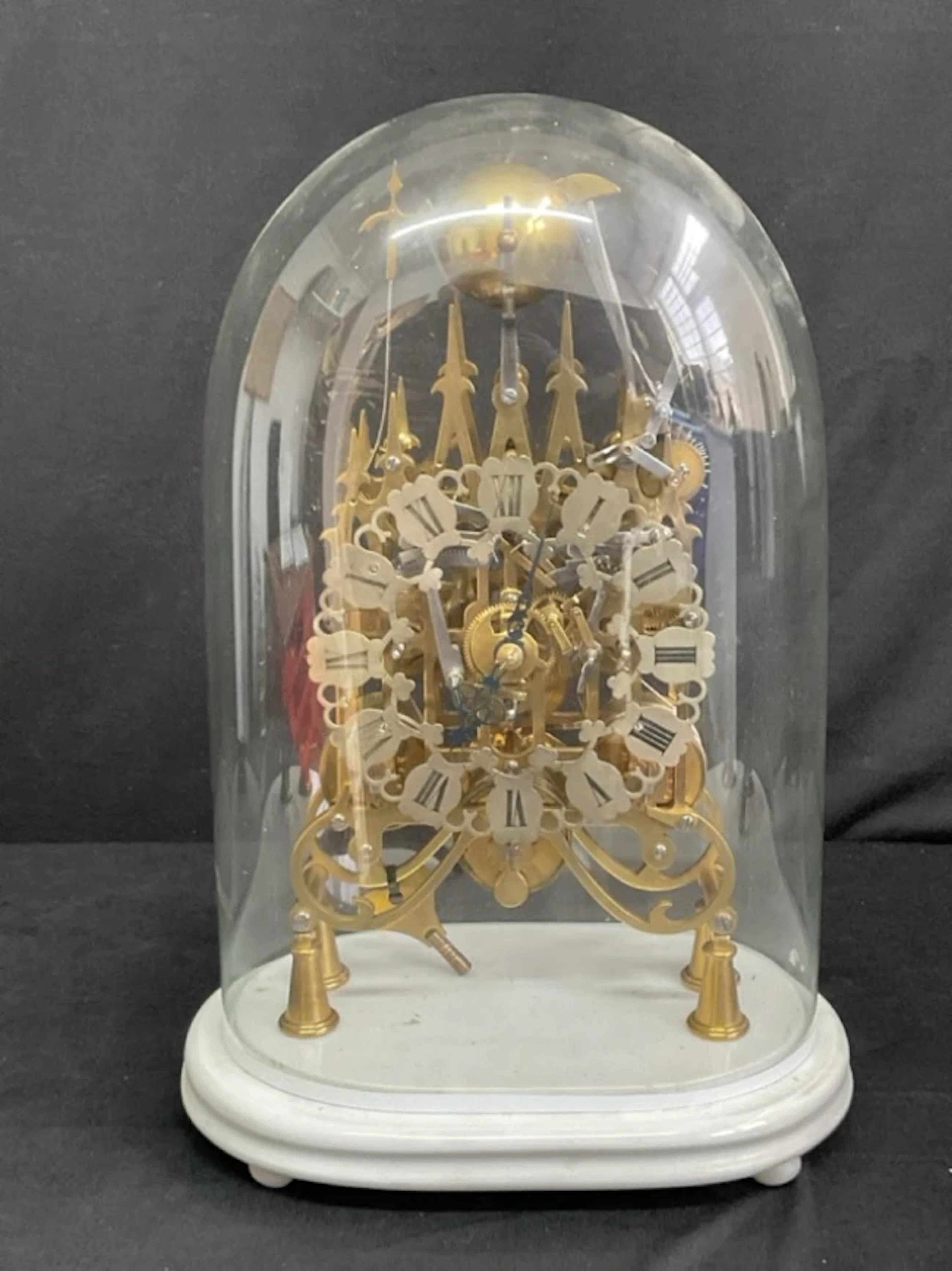 A C19th English glass domed brass triple fusée gothic skeleton clock