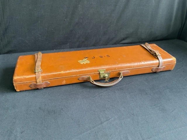 A Holland & Holland leather gun case with baize lined fitted interior