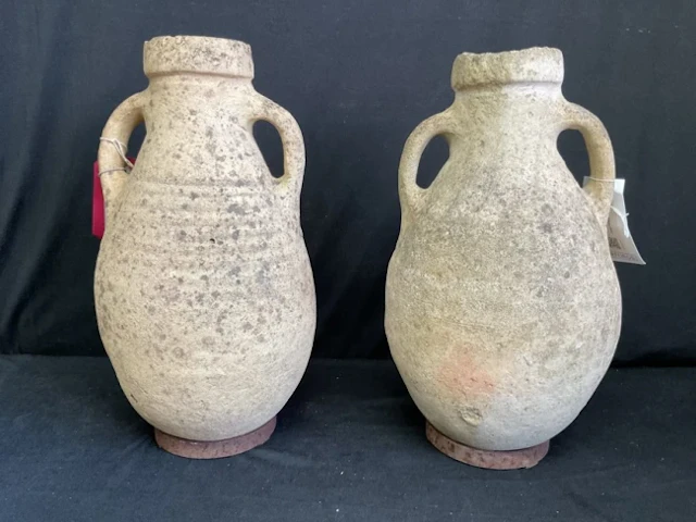 A pair of antique North African hand thrown terracotta amphorae with
