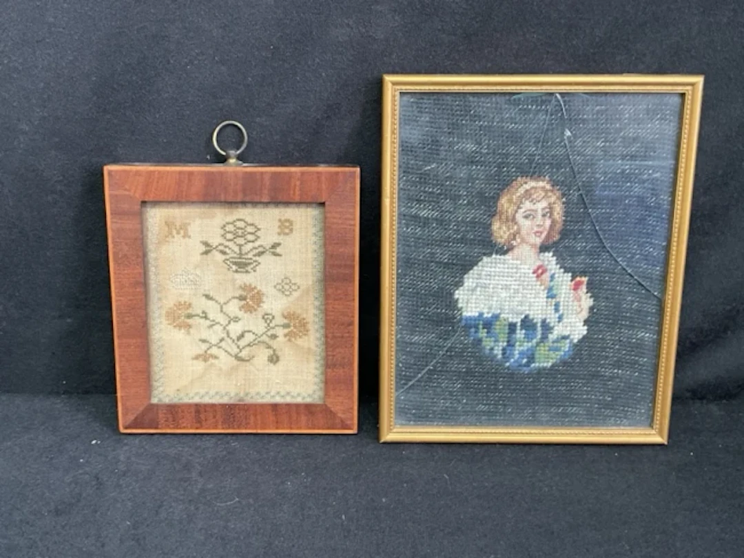 A Georgian miniature sampler worked in silks on linen depicting flowers