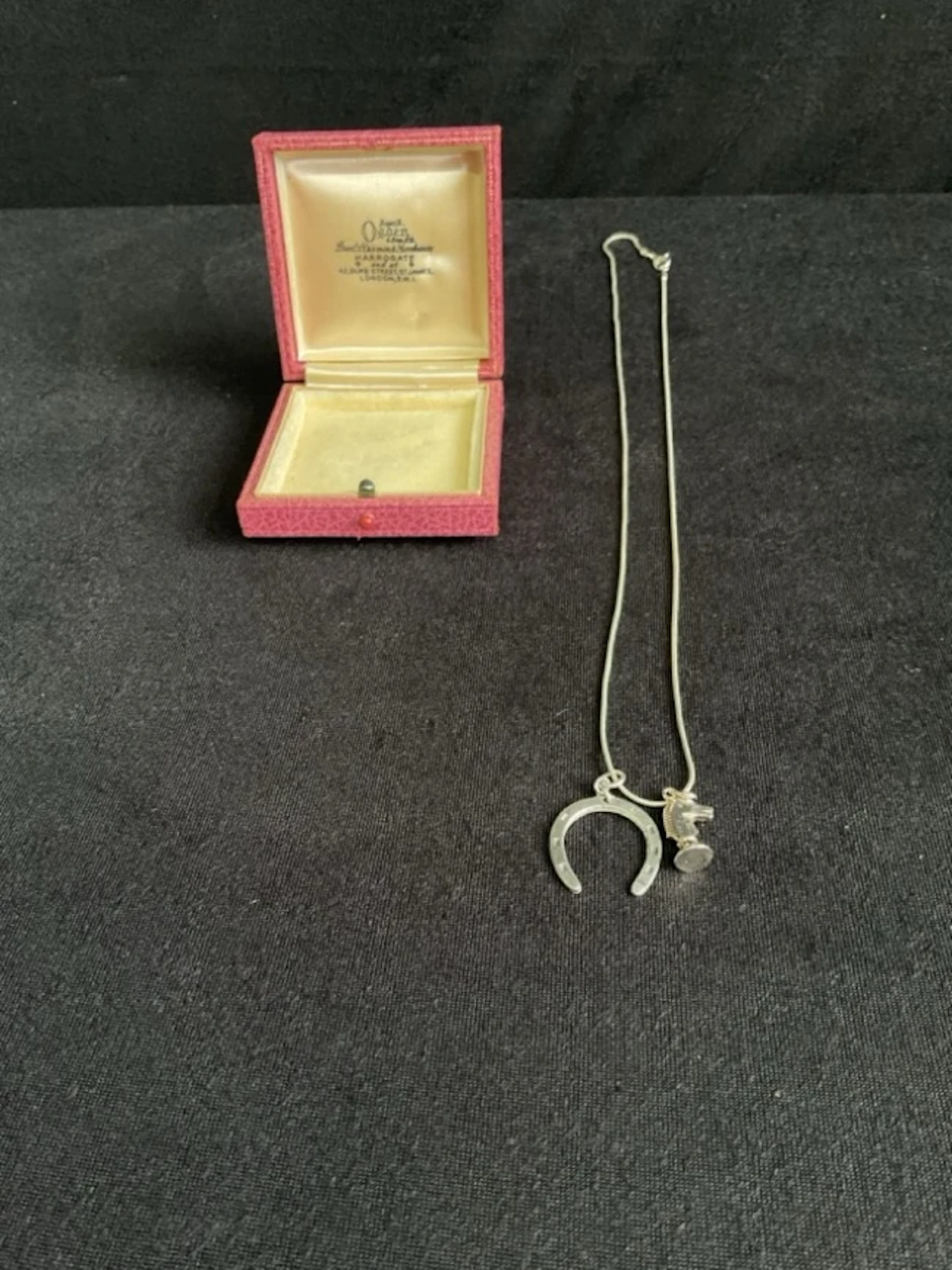 A hallmarked silver horseshoe pendant by SJ Rose & Son, Birmingham