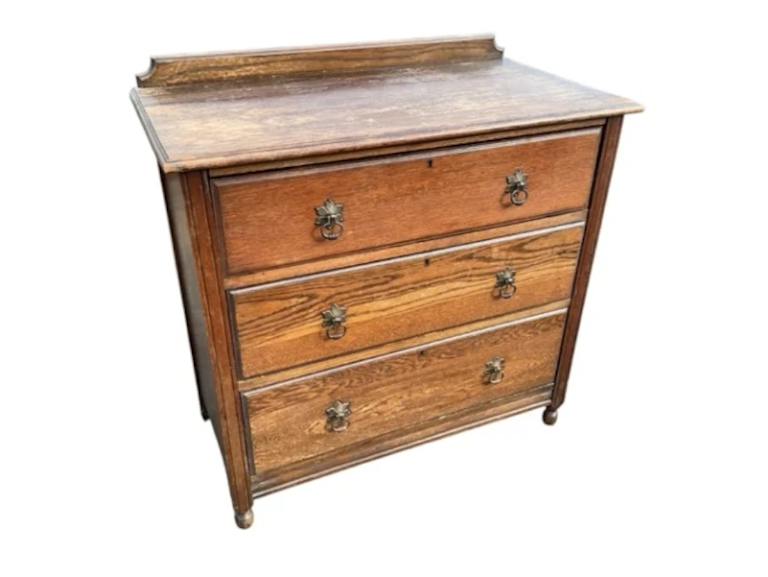 An oak chest with shaped upstand back and rectangular moulded top