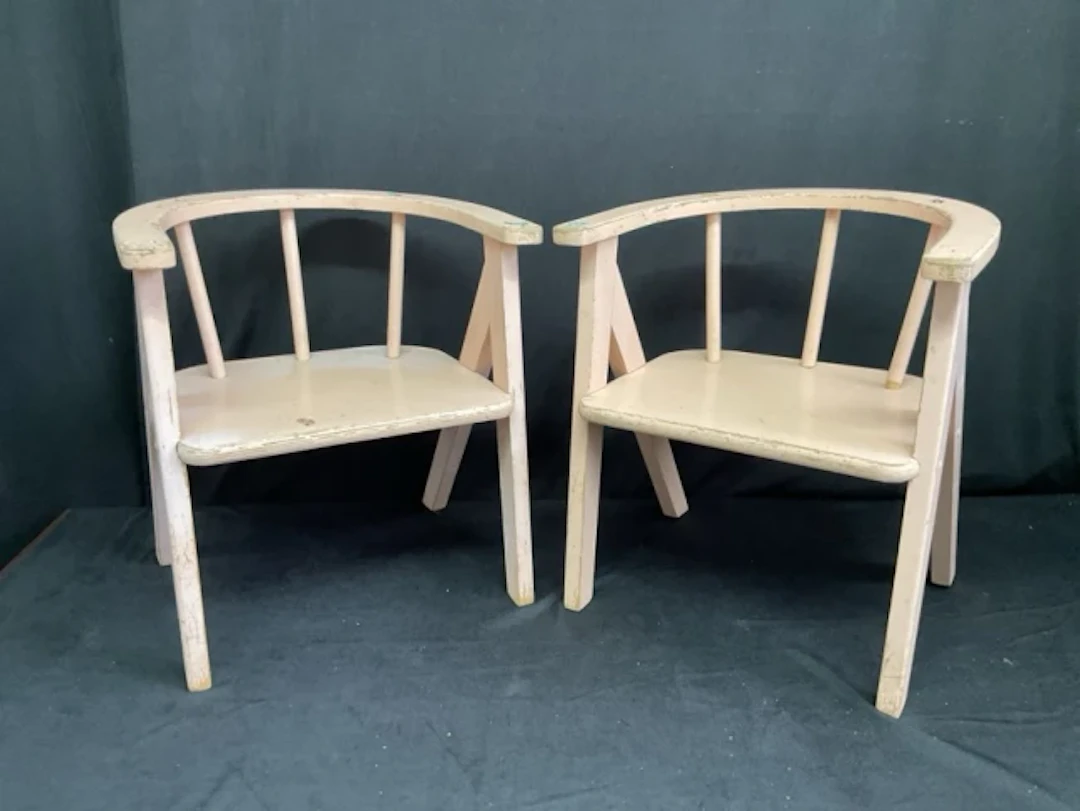 A pair of 50s painted childs chairs by Atcraft with rounded arms on
