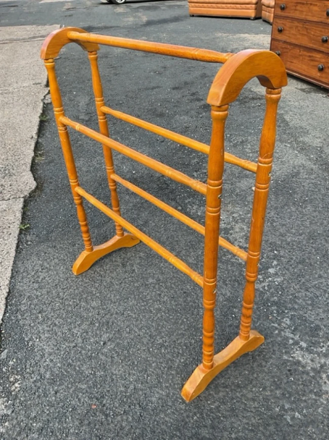 A Victorian style hardwood towel rail with arched ends on turned supports