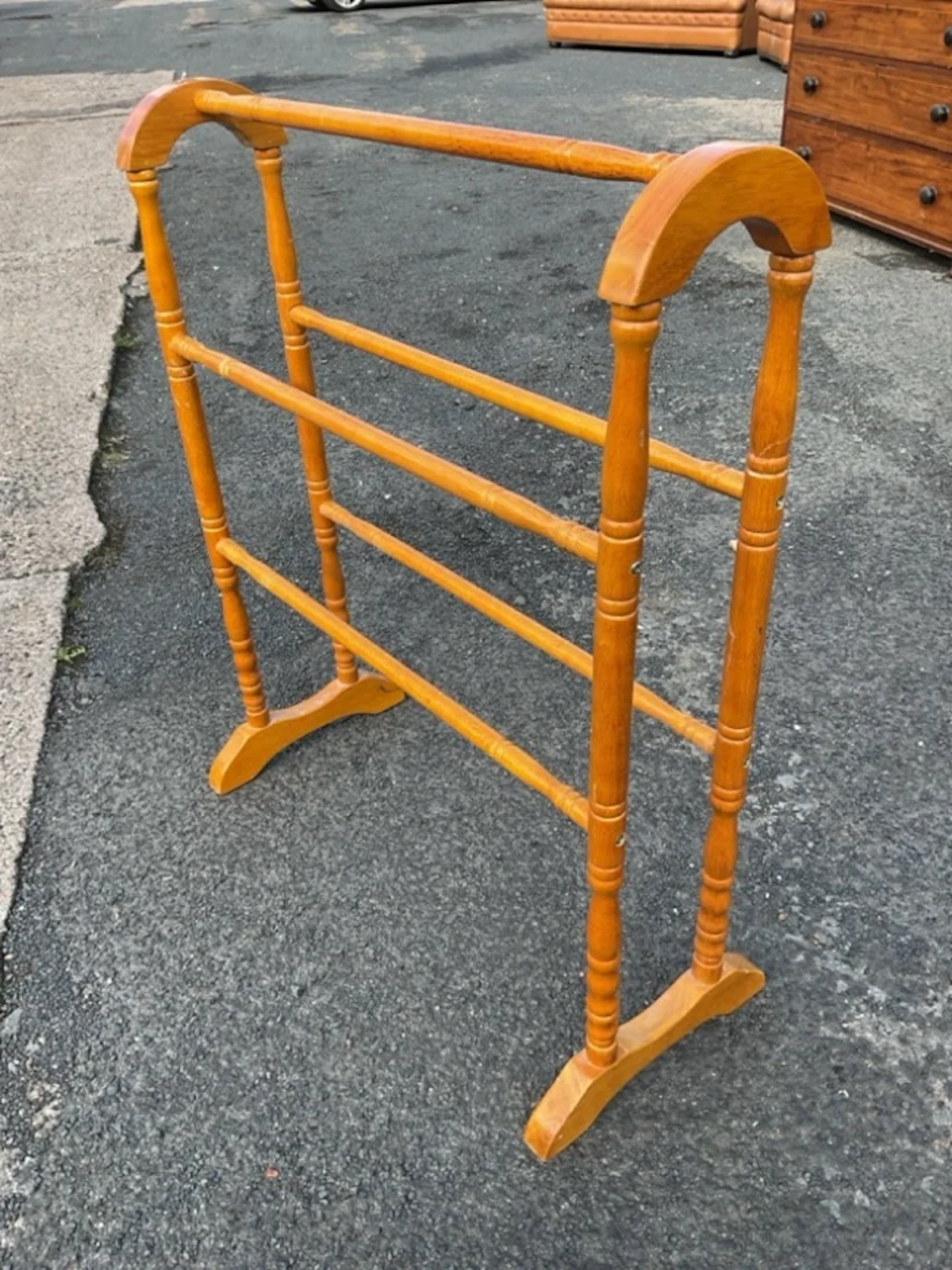 A Victorian style hardwood towel rail with arched ends on turned supports