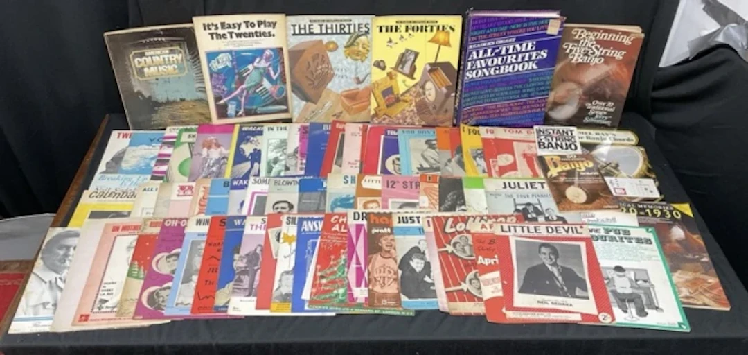 A collection of sheet music and music books including 50s & 60s popular