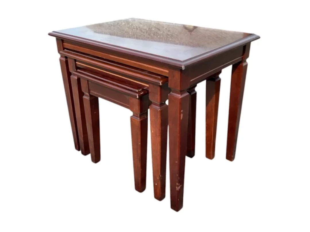 A nest of three mahogany tables with rectangular moulded tops on square