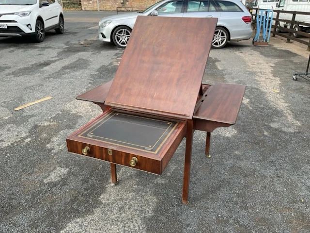 A Georgian mahogany architects table having drawer with slide and
