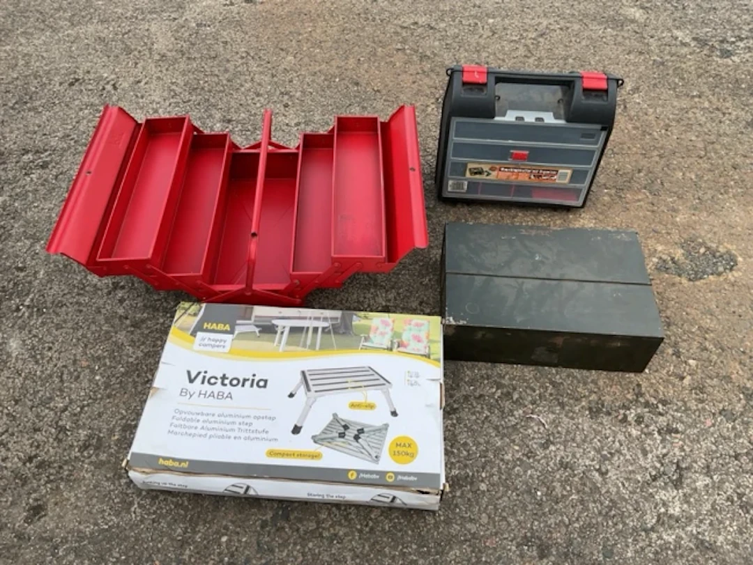 A boxed folding aluminium step stool; an unused concertina style metal