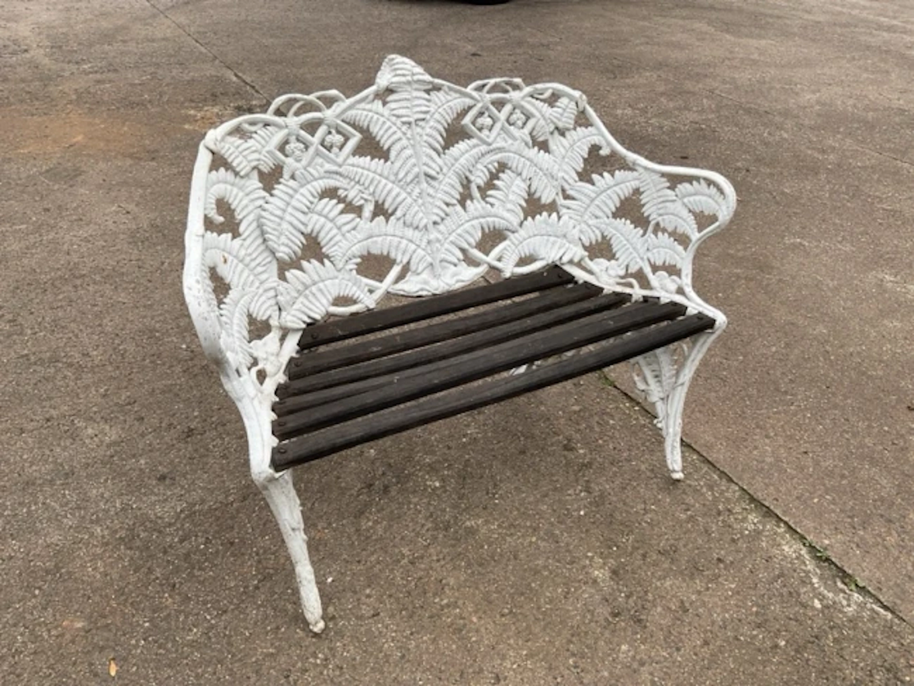 A painted Coalbrookdale style garden bench cast in the fern pattern