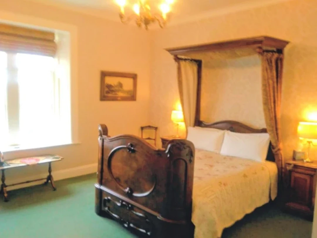 A Victorian mahogany half-tester 5ft double bed, the canopy with moulded