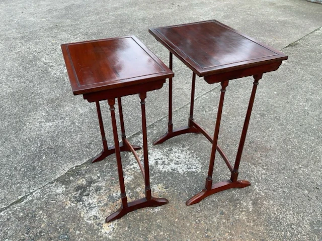 A pair of regency style mahogany nesting tables with rectangular tops