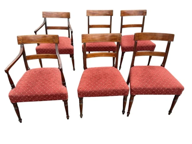 A set of six regency mahogany dining chairs with two carvers, the
