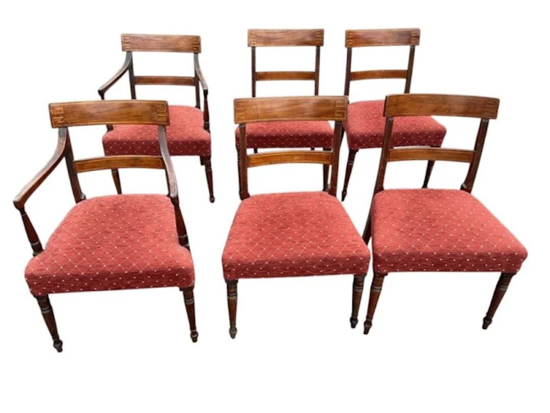 A set of six regency mahogany dining chairs with two carvers, the