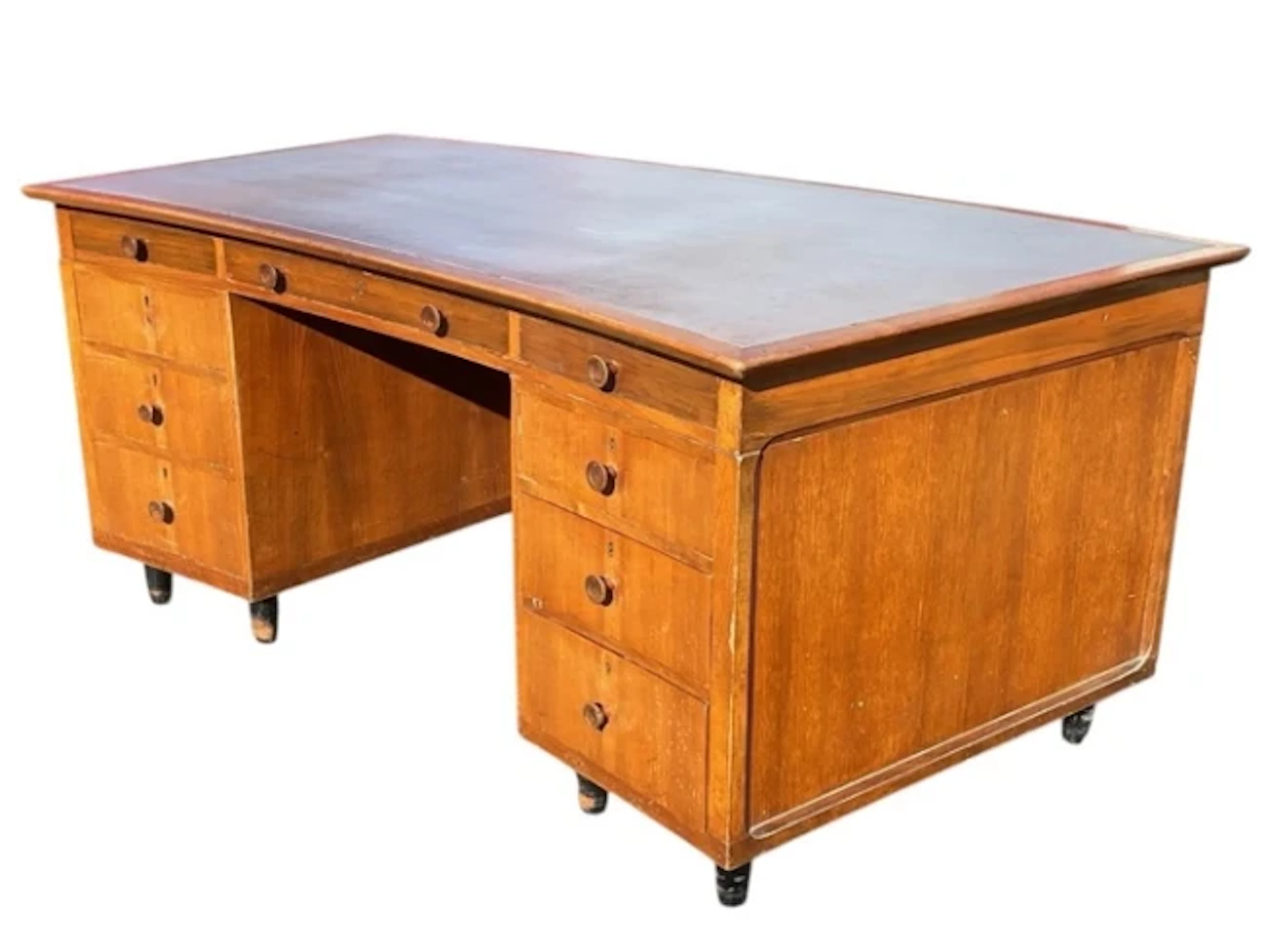 A 50s walnut Catesby desk of crescent shape with inset writing surface
