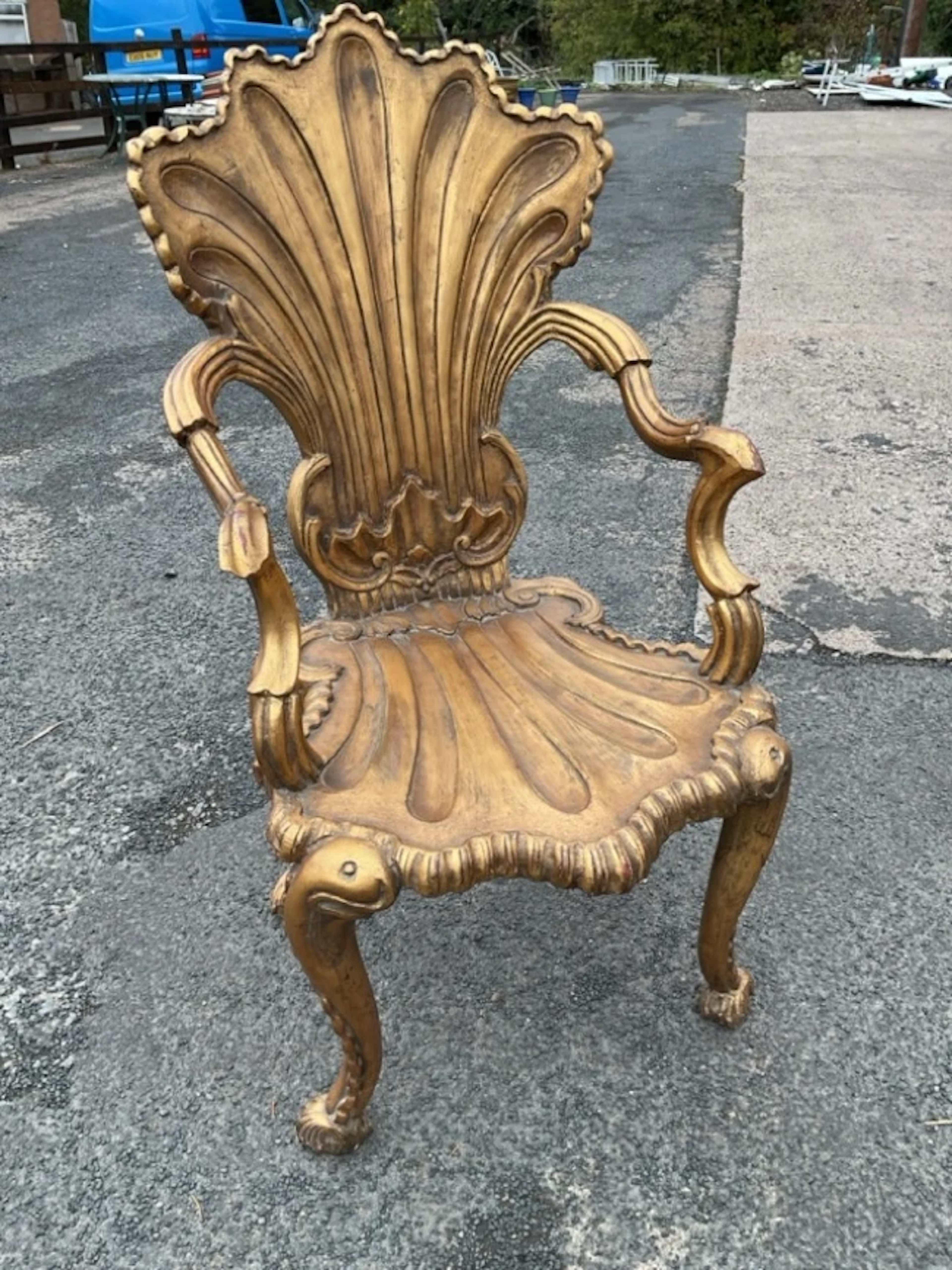 A C19th Italian giltwood grotto armchair with deeply carved shell