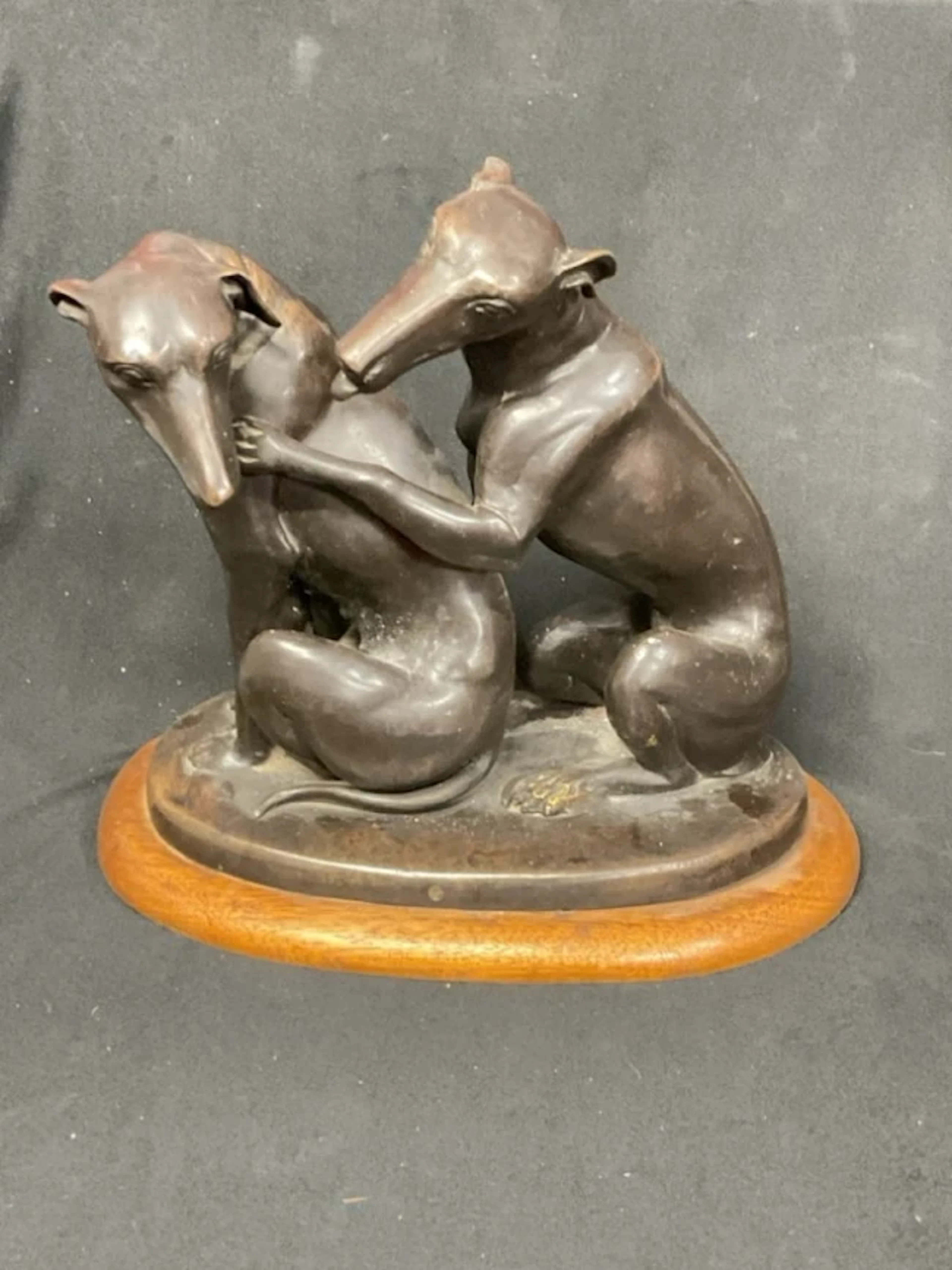 A Roman style bronze figure group of a pair of seated amourous greyhounds