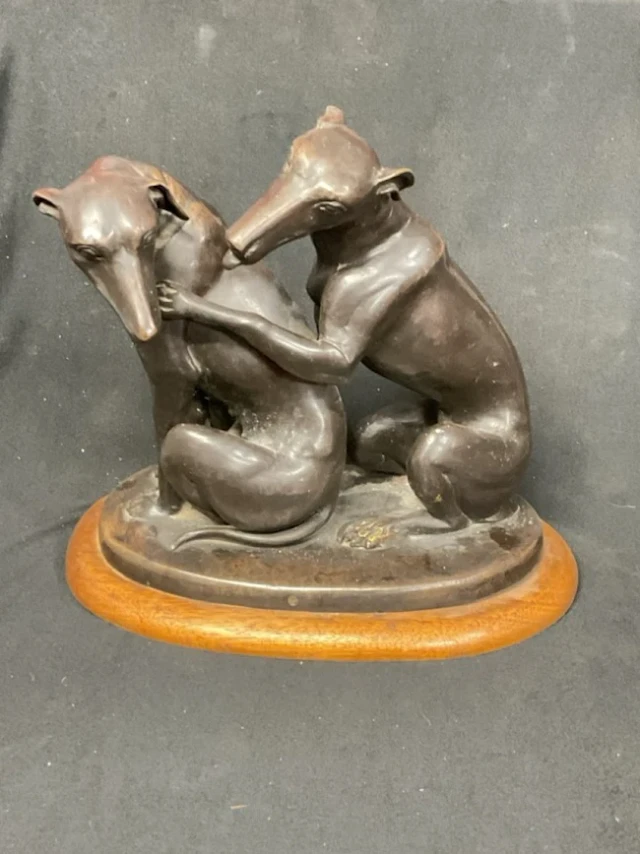 Bronze, a Roman style pair of seated amourous greyhounds, on an oval