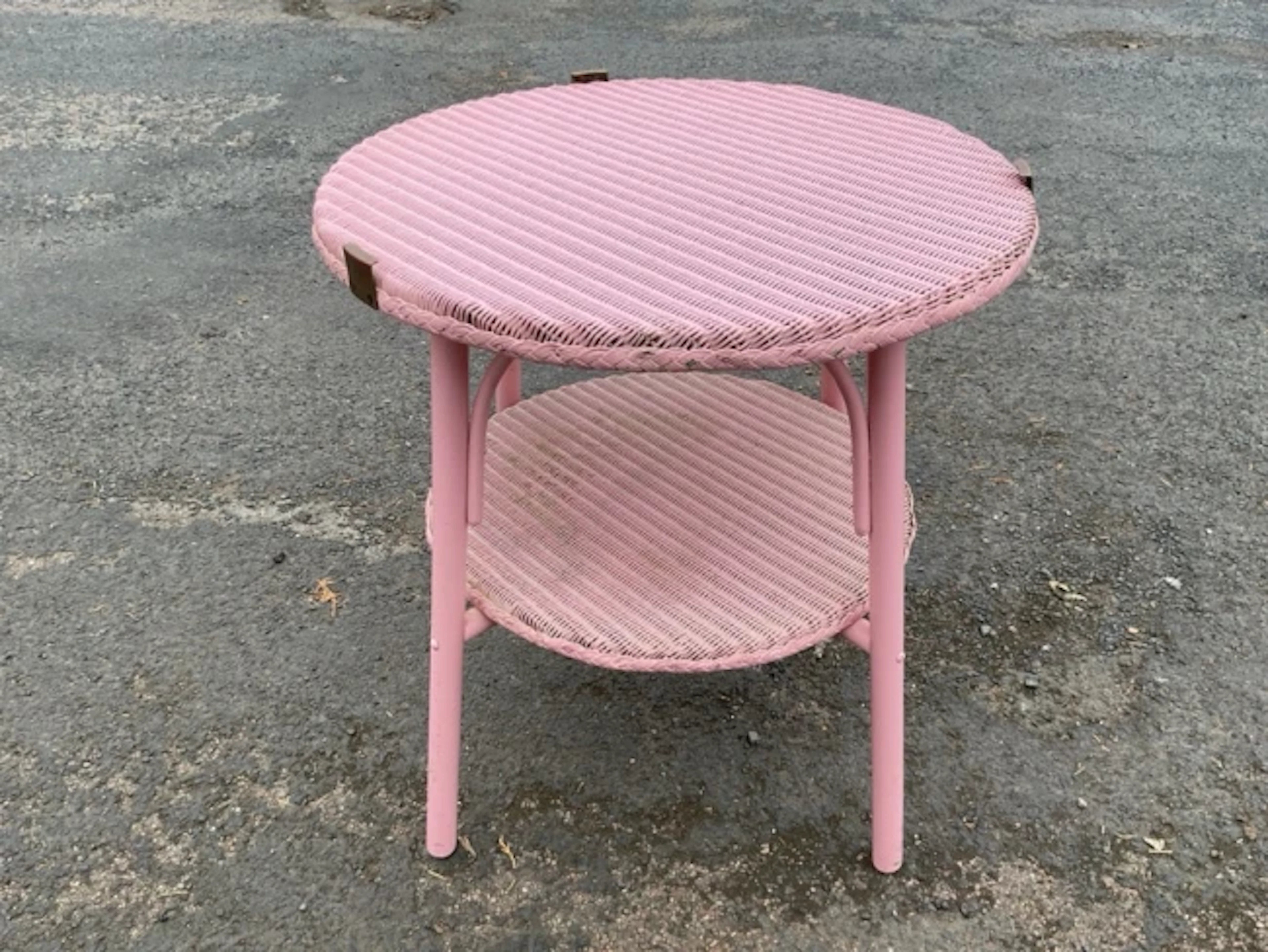 A painted circular cane coffee table, formerly having glass top, raised