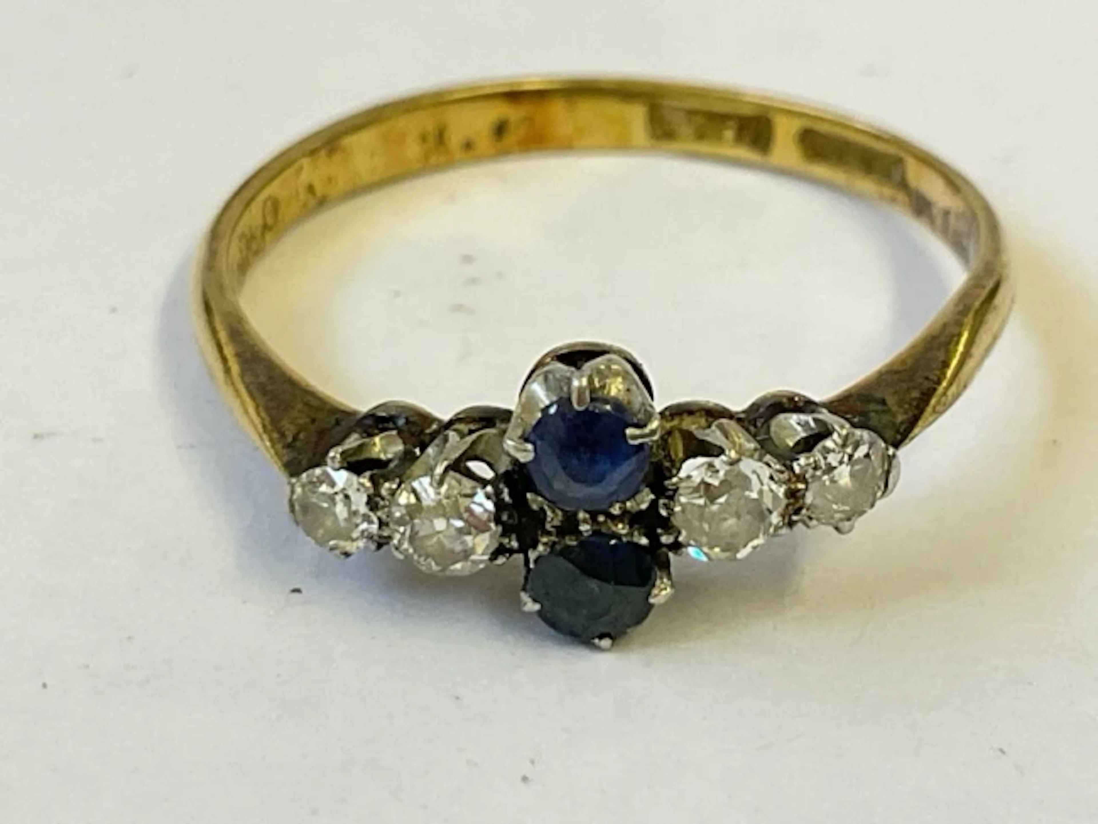 An antique 18ct gold ring with a pair of vertically mounted sapphires