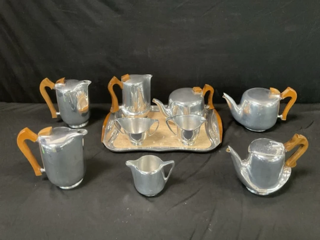 A collection of cast aluminium Piquot Ware - a tea & coffee set with