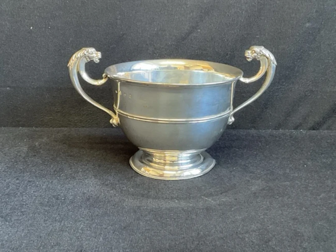 An Edinburgh hallmarked silver bowl with scrolled gryphon handles
