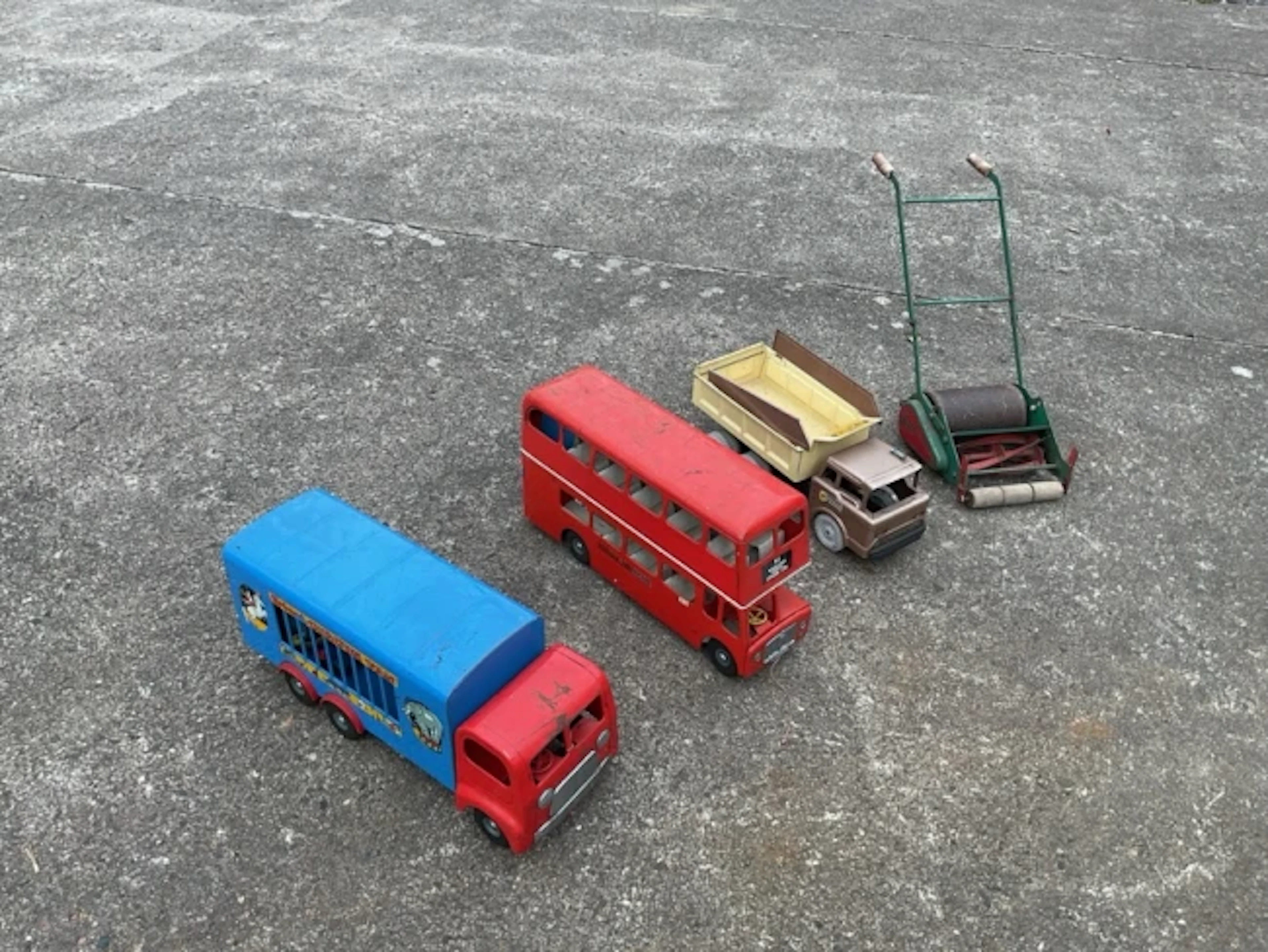A Tri-ang metal circus van with animals; a similar tinplate London