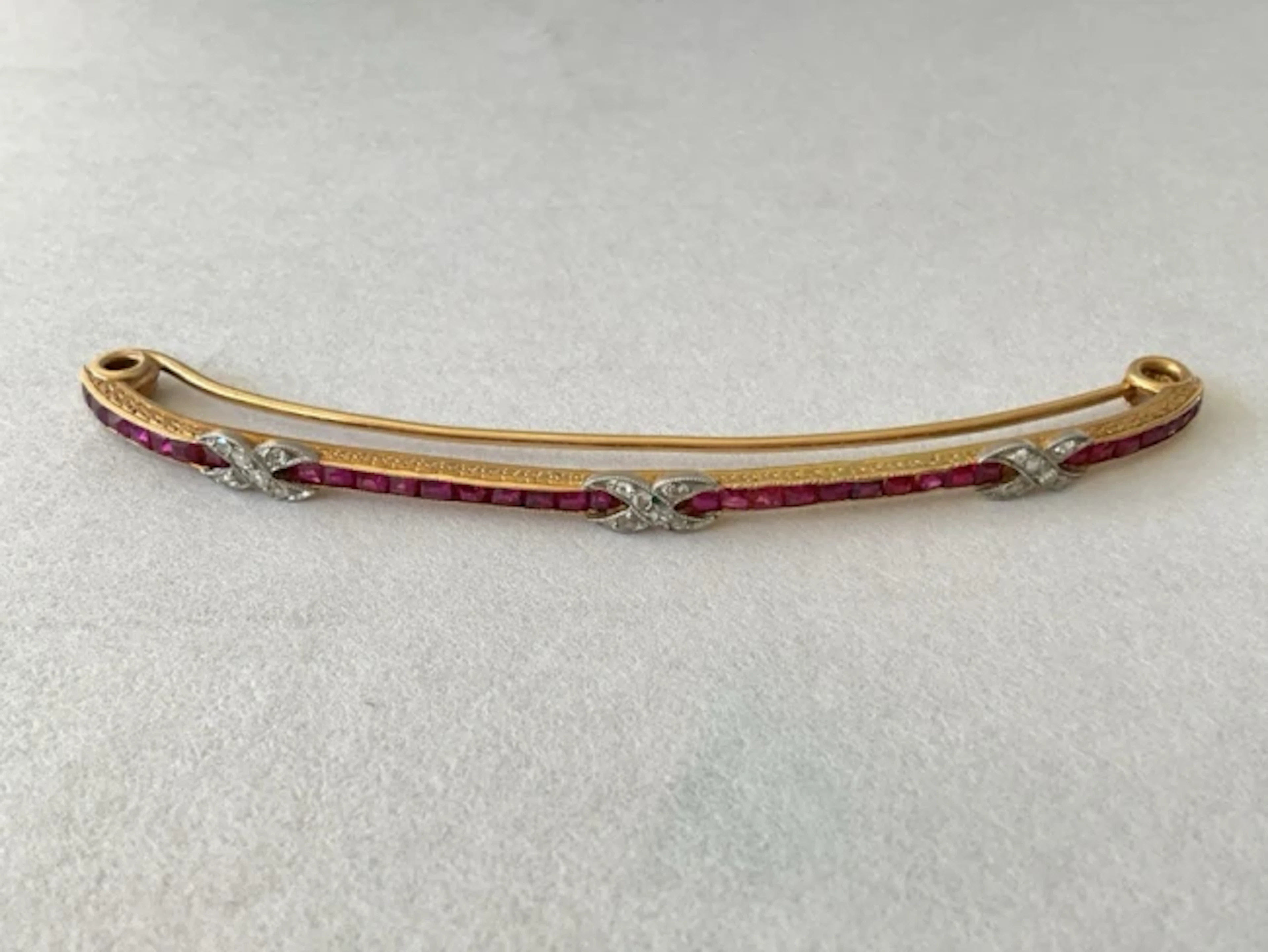 An antique French 18ct gold hair clip, channel set with rubies and