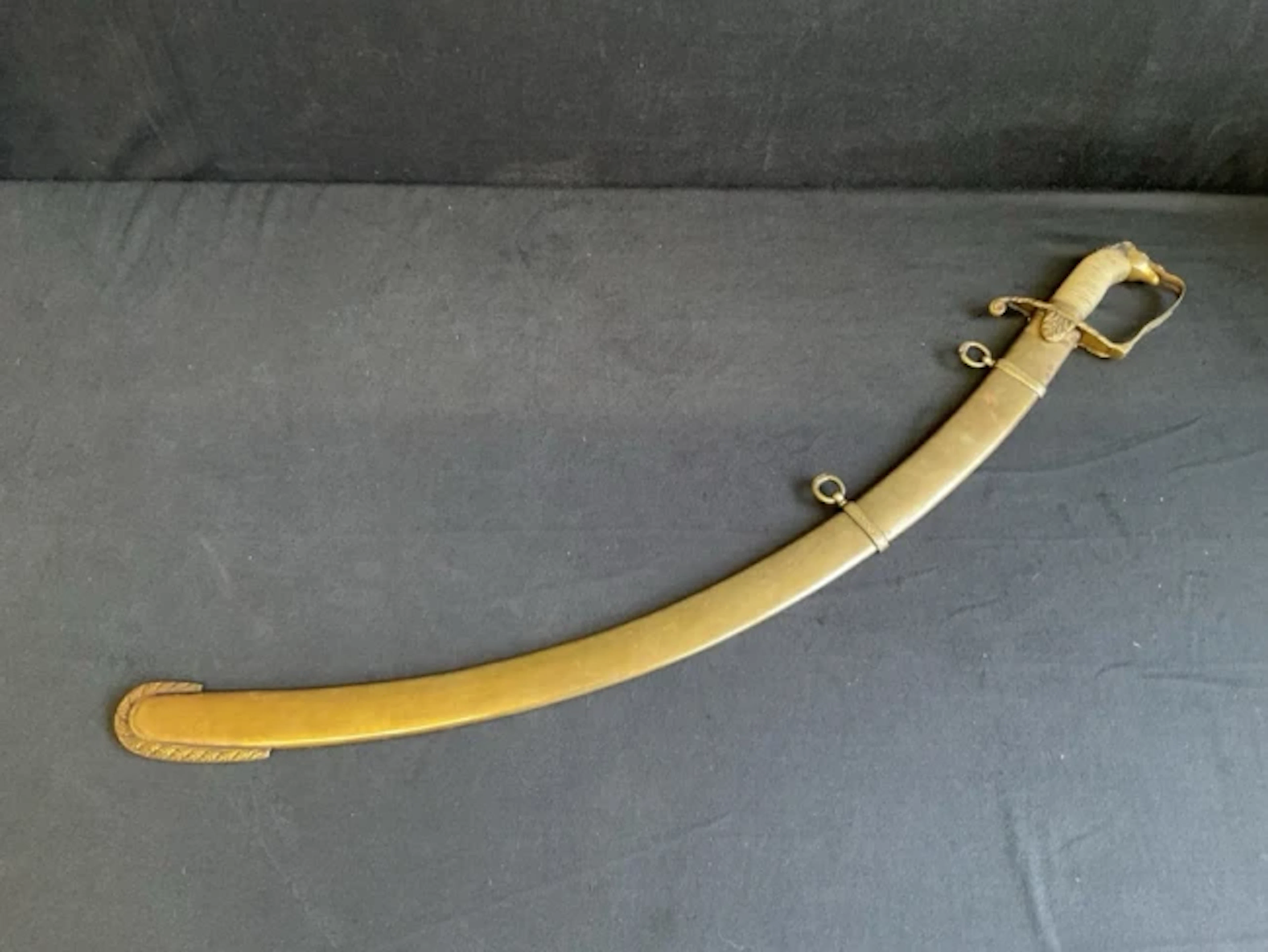 An early C19th officers sabre with brass hilt, horse head pommel