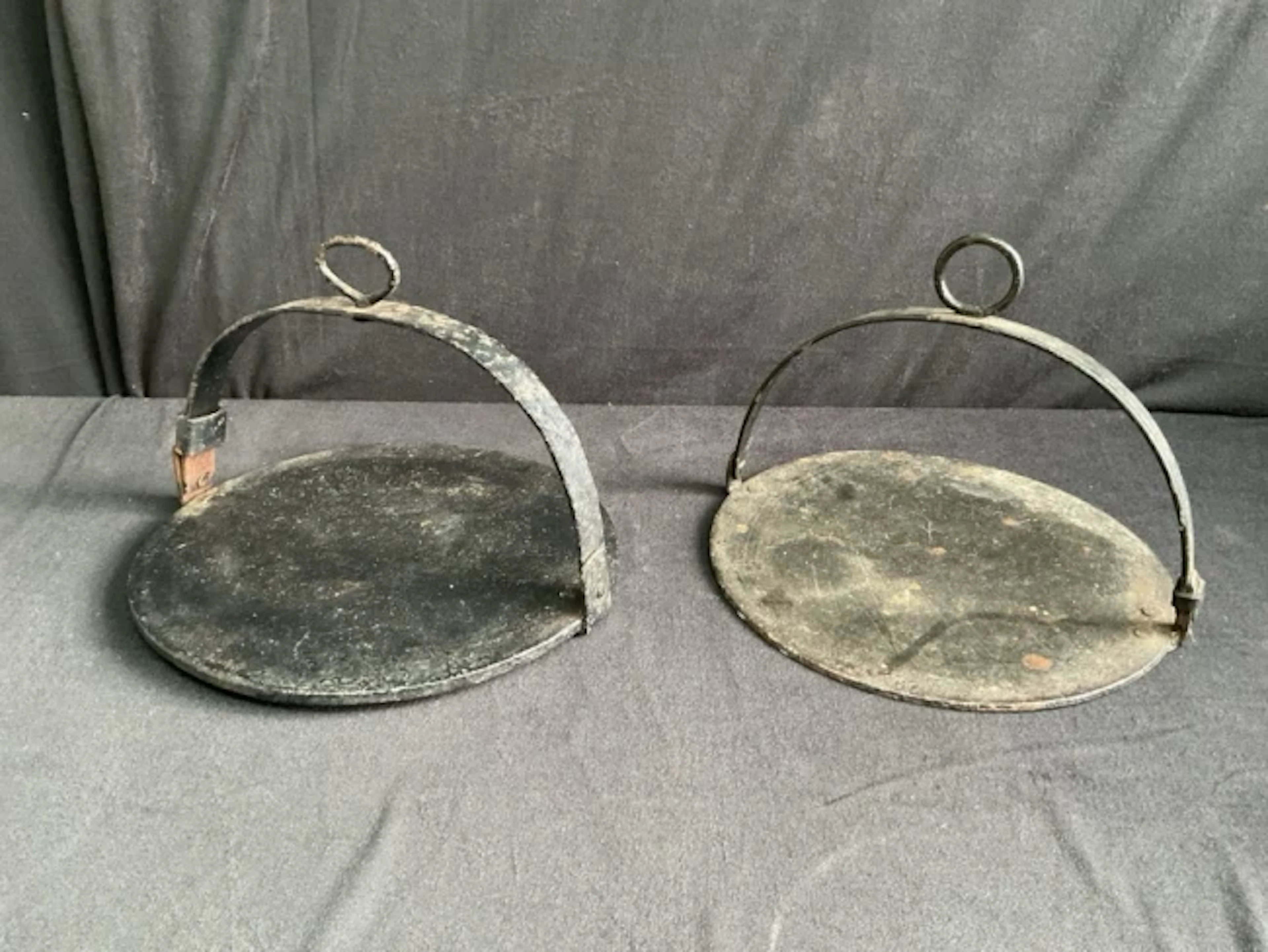 Two Victorian circular cast iron griddle plates with arched wrought