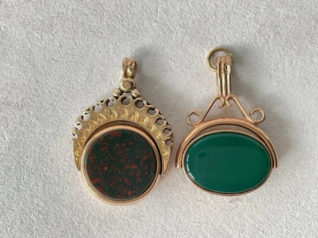A 9ct gold fob with mother of pearl and green stone ovals in foliate