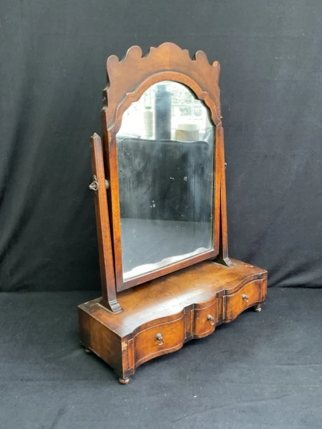 A walnut George II style dressing table mirror with fretwork crest