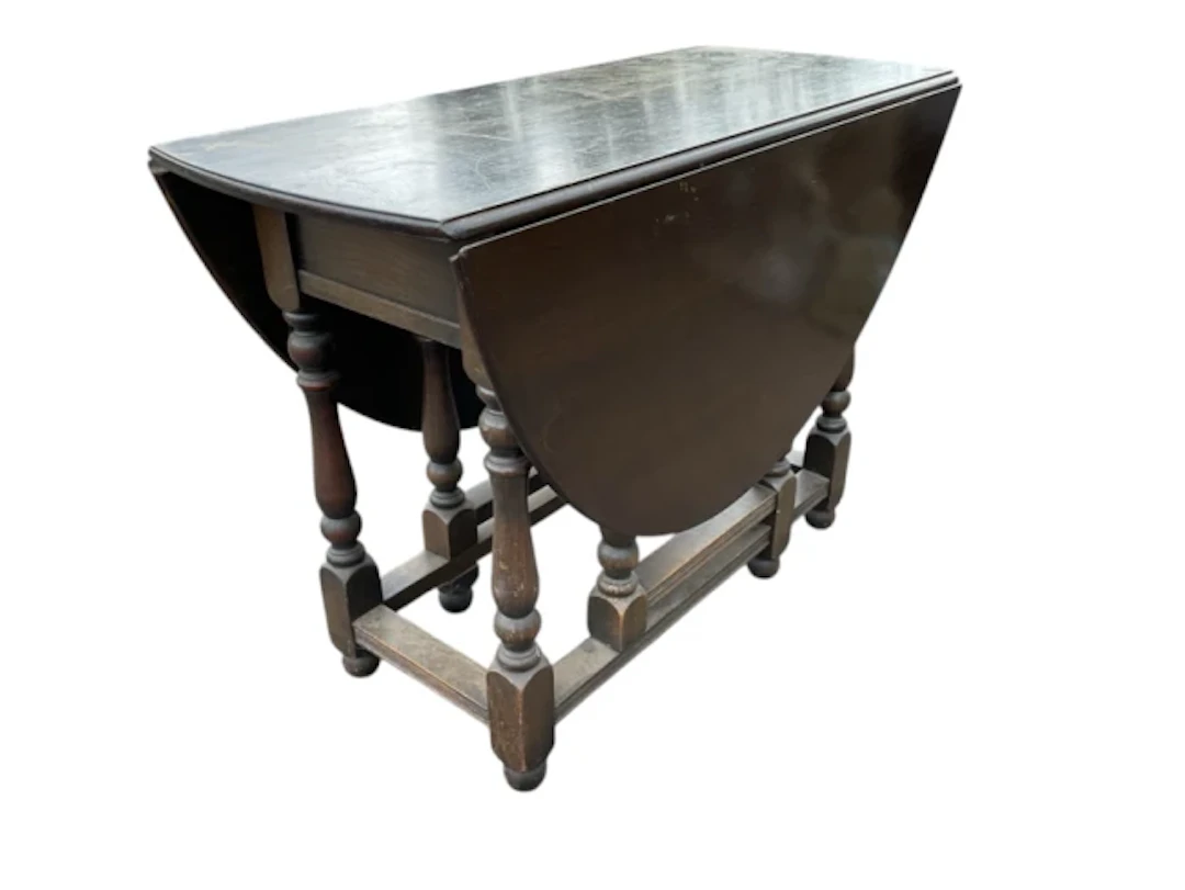 A Georgian style oak gateleg table, the oval moulded top with two
