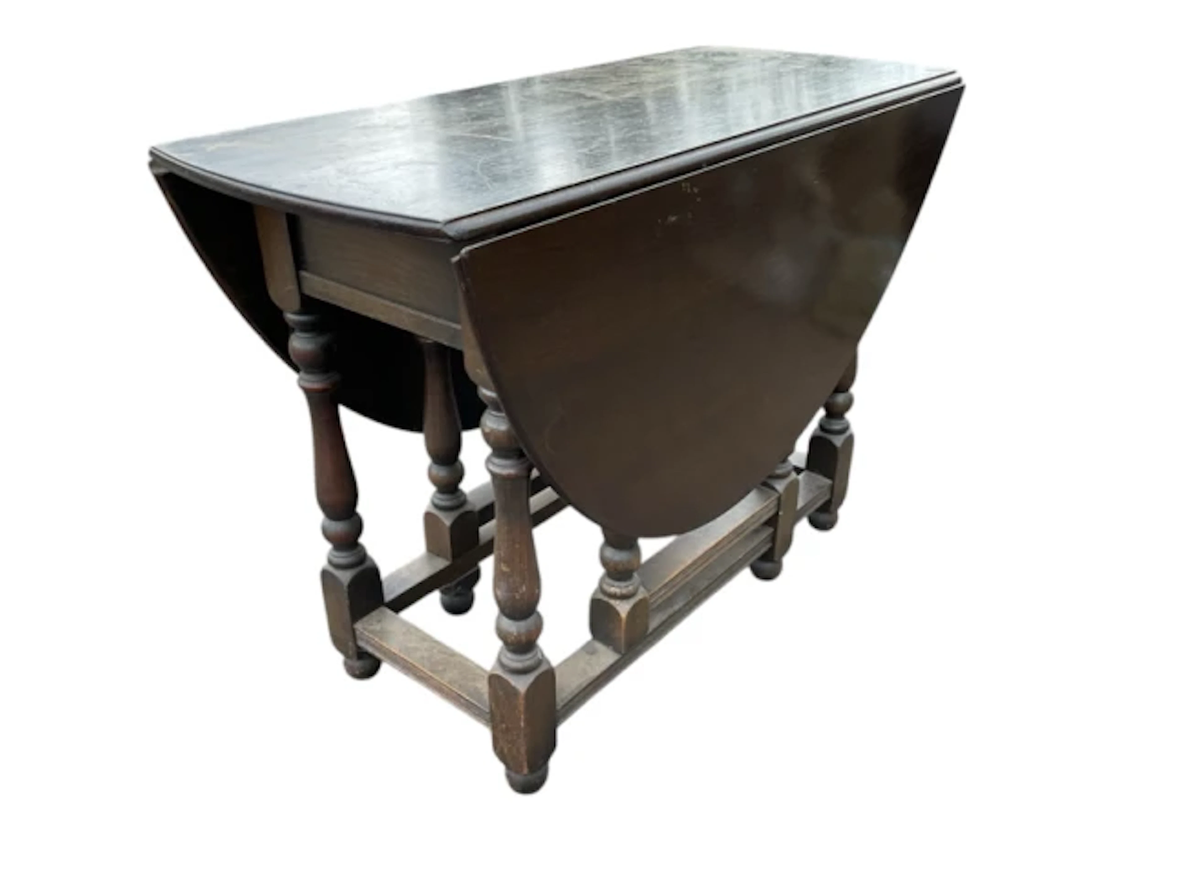 A Georgian style oak gateleg table, the oval moulded top with two