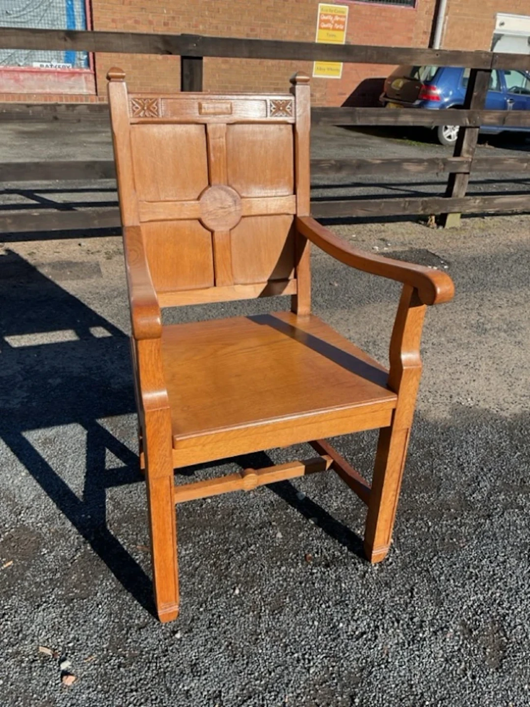 A craftsman made oak armchair having panelled back carved with rectangular