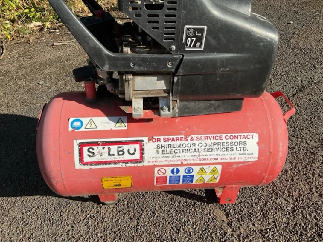 An electric air compressor with tank below electric motor - A/F. (29in)
