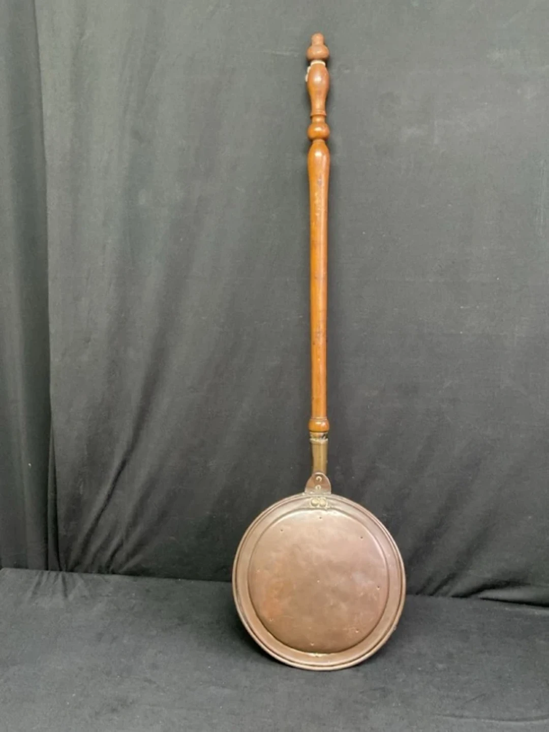 A Victorian copper bed warmer with hinged cover and turned walnut