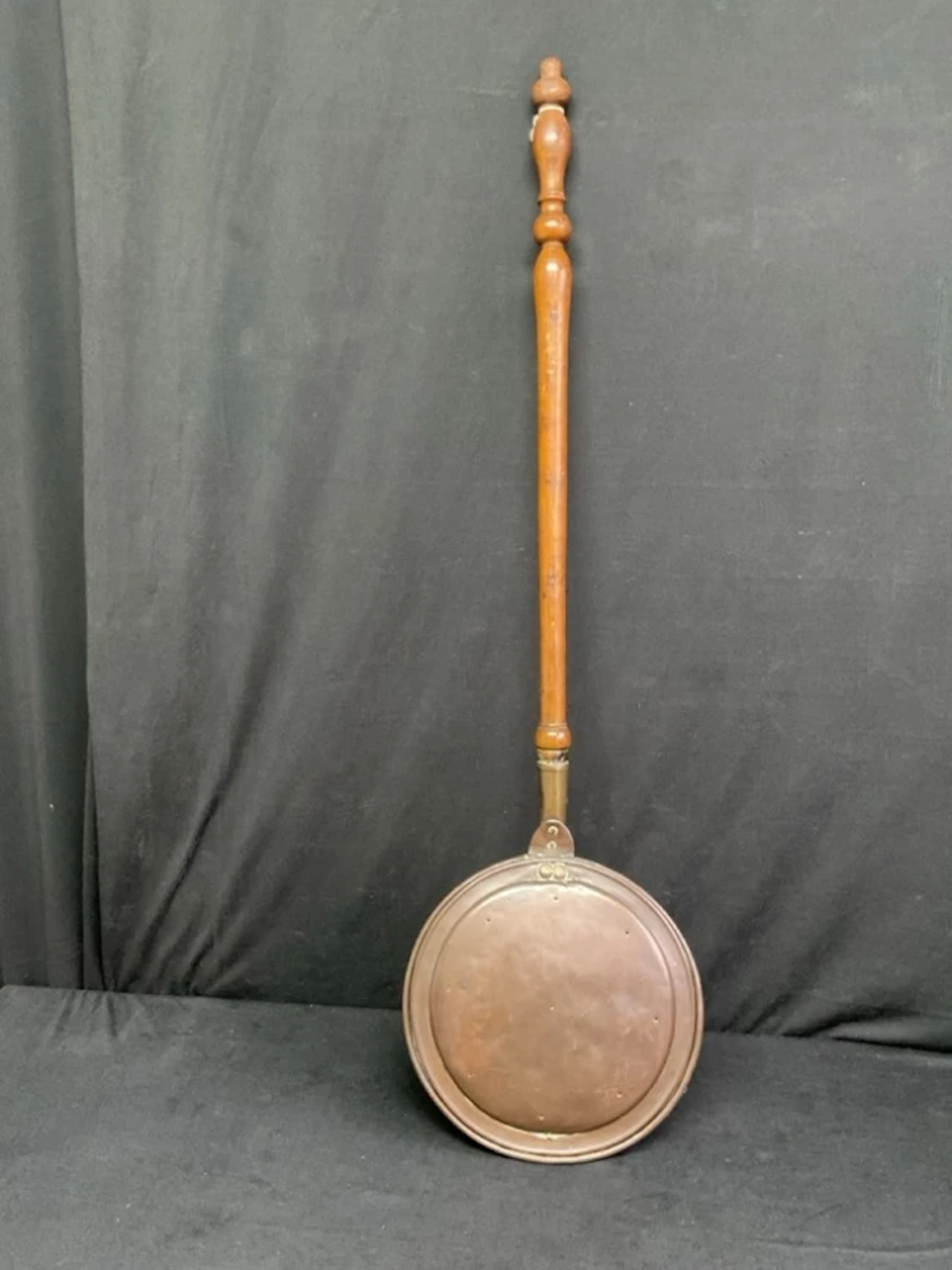 A Victorian copper bed warmer with hinged cover and turned walnut