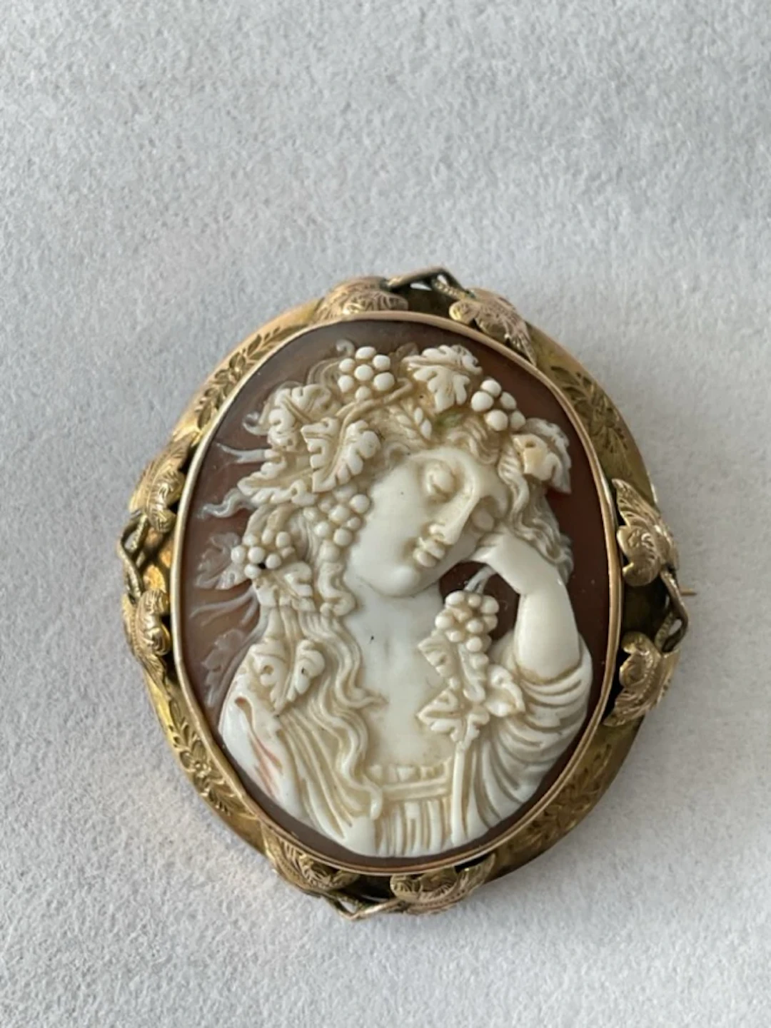 An antique shell cameo brooch depicting portrait of Bacchante, mounted