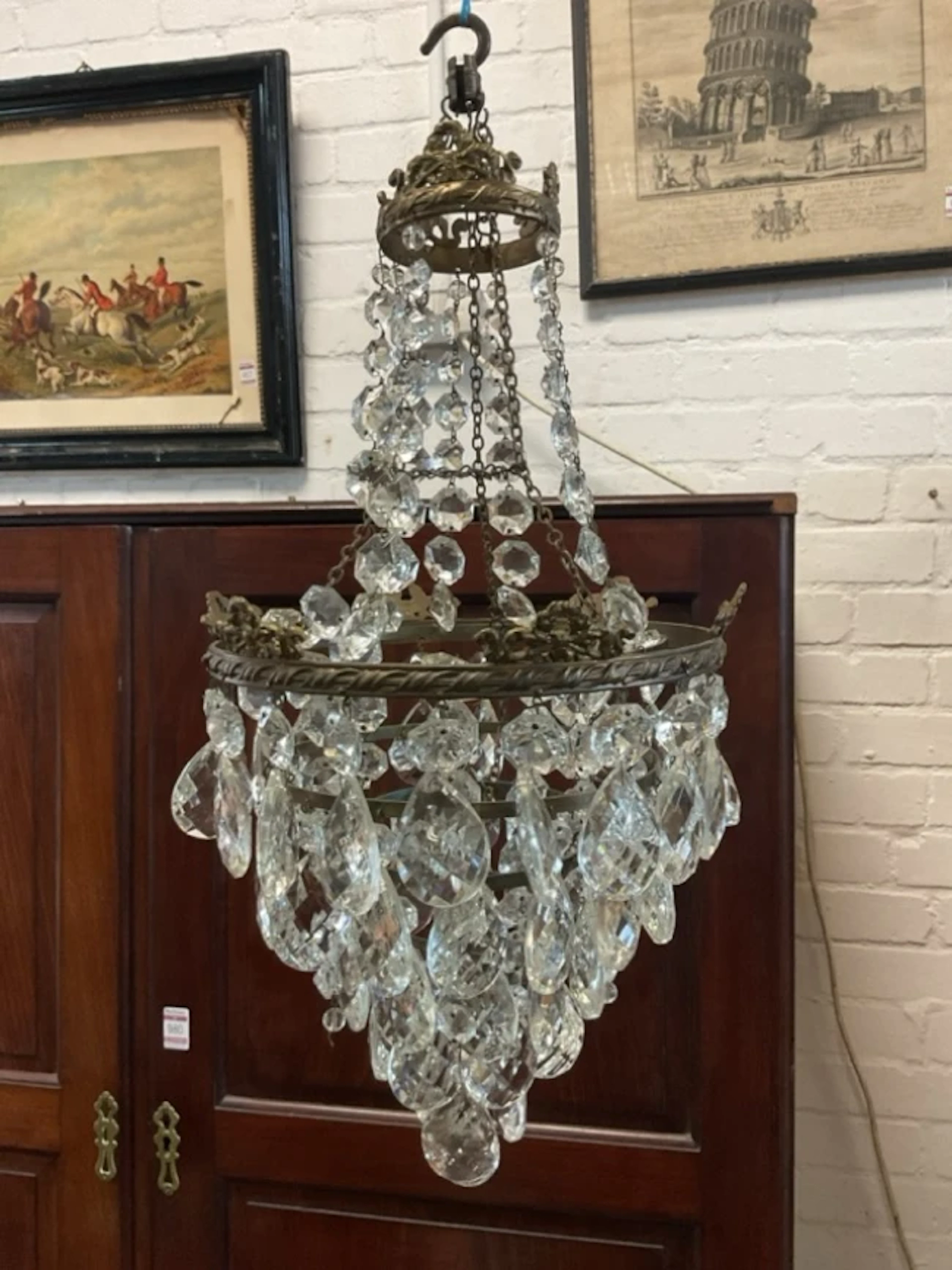 An Edwardian cut crystal chandelier with circular brass ribbon twist