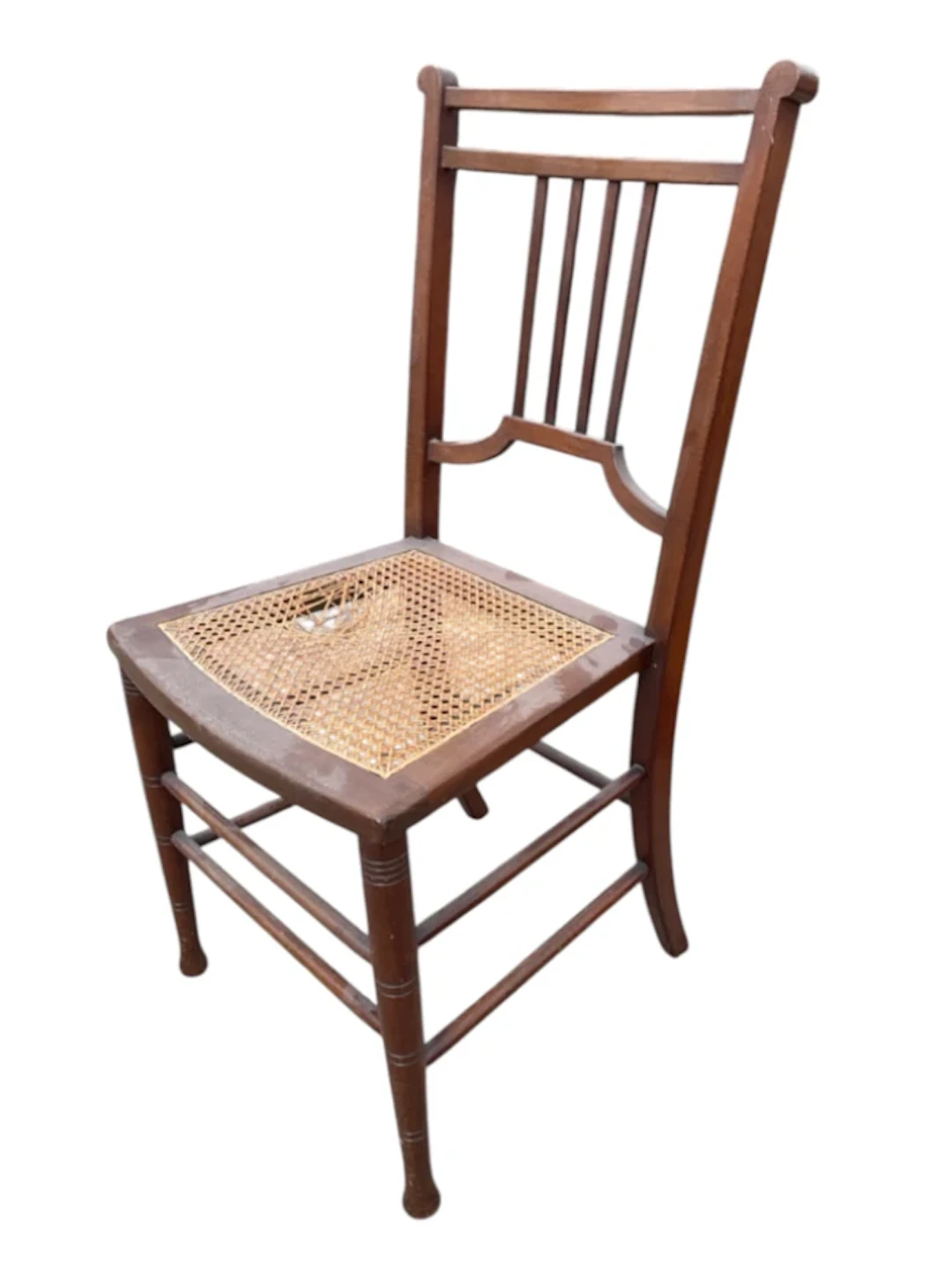 An Edwardian mahogany chair with narrow slats to back above a caned