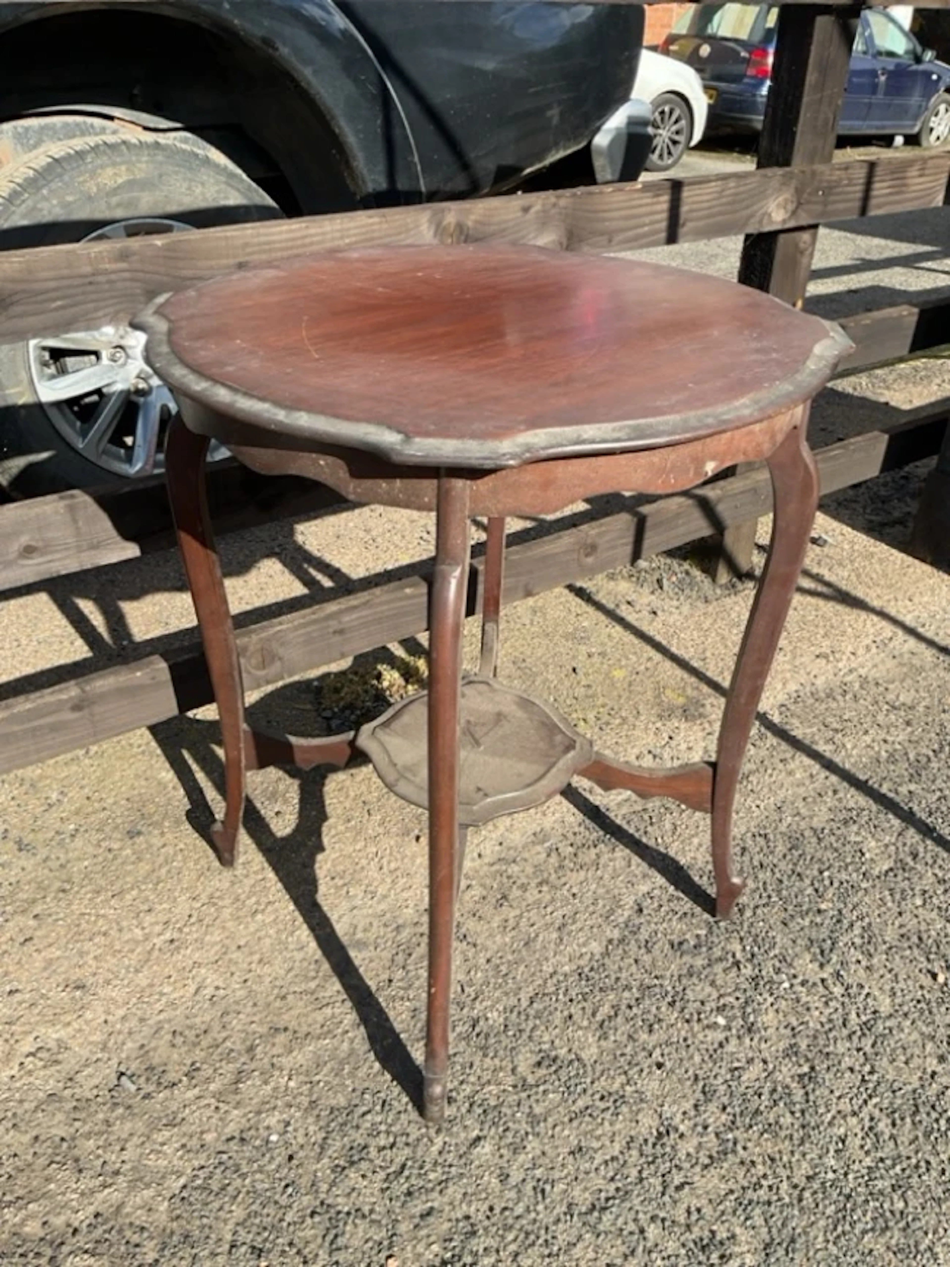 A circular Edwardian mahogany occasional table with moulded top on