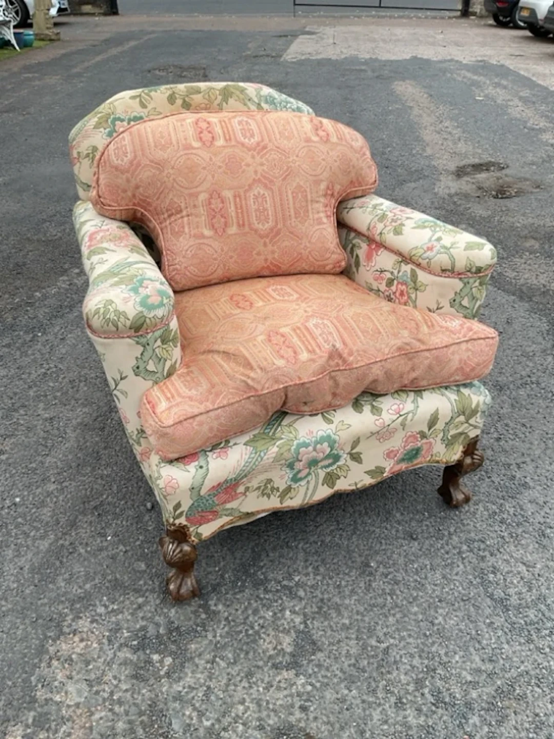 An Edwardian upholstered armchair with arched back and rectangular