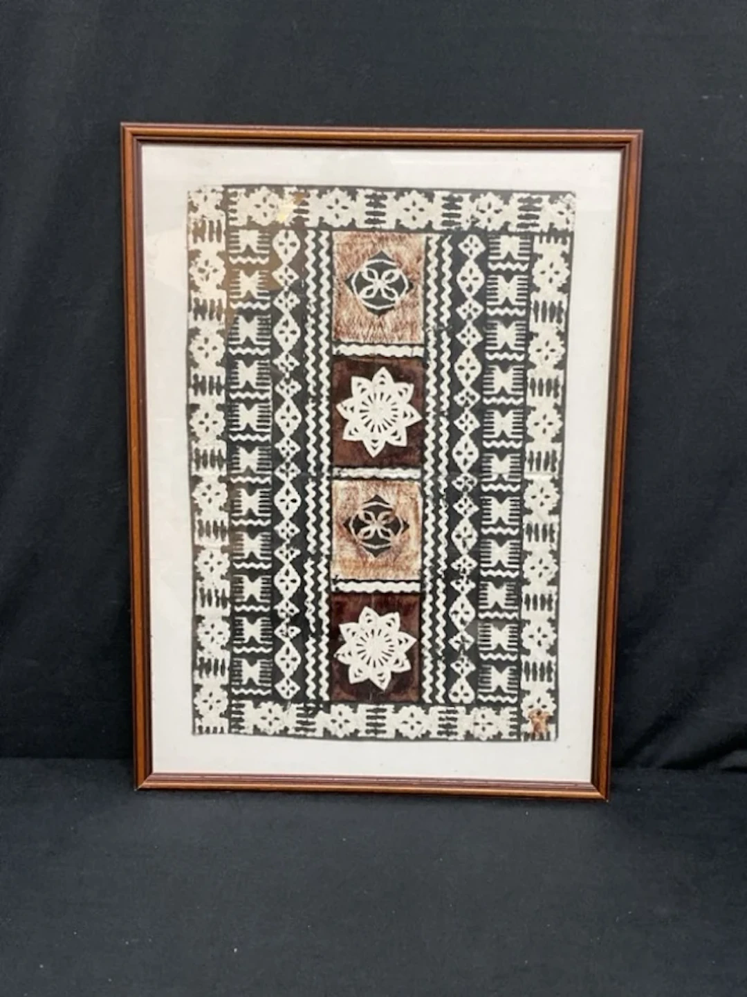 A Polynesian block printed tapa cloth panel with flowerhead motifs