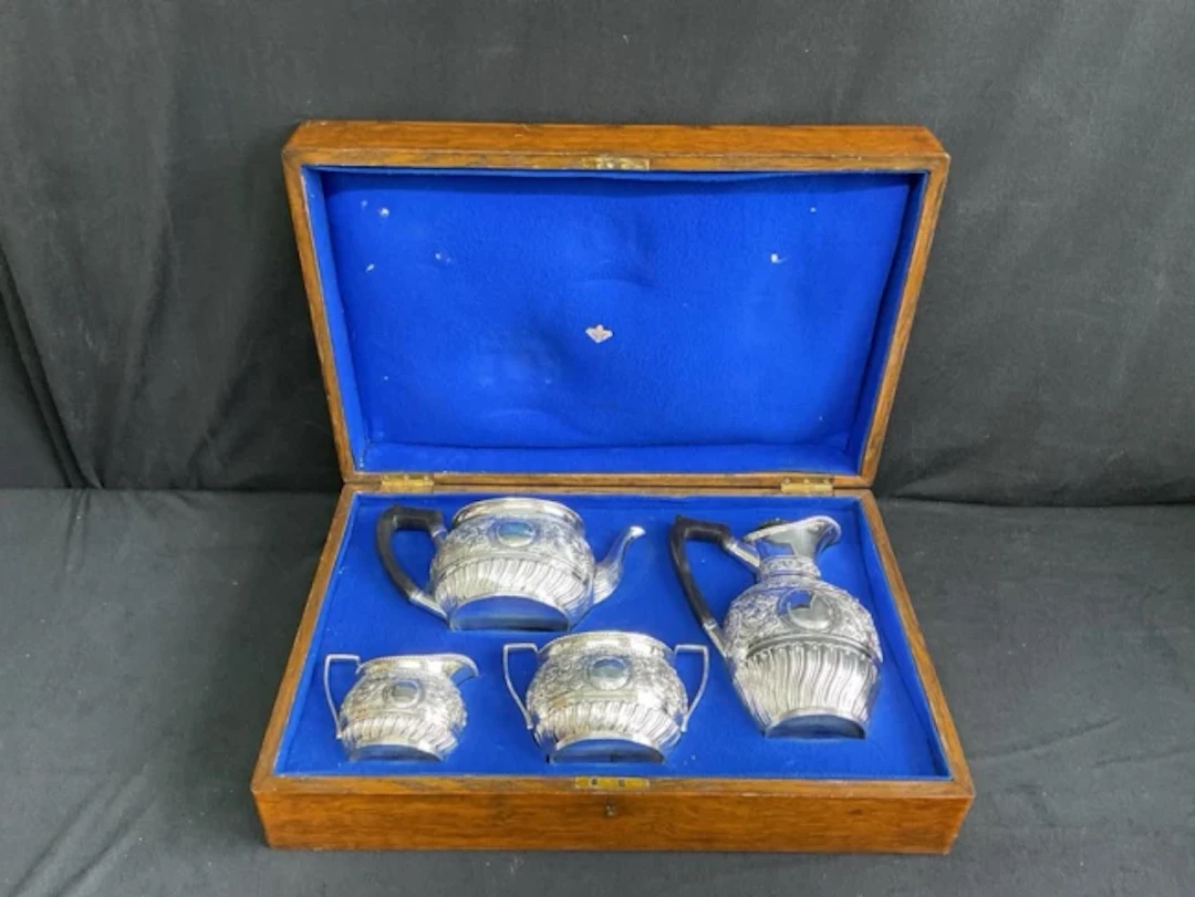 A Victorian oak cased hallmarked silver four-piece tea and coffee