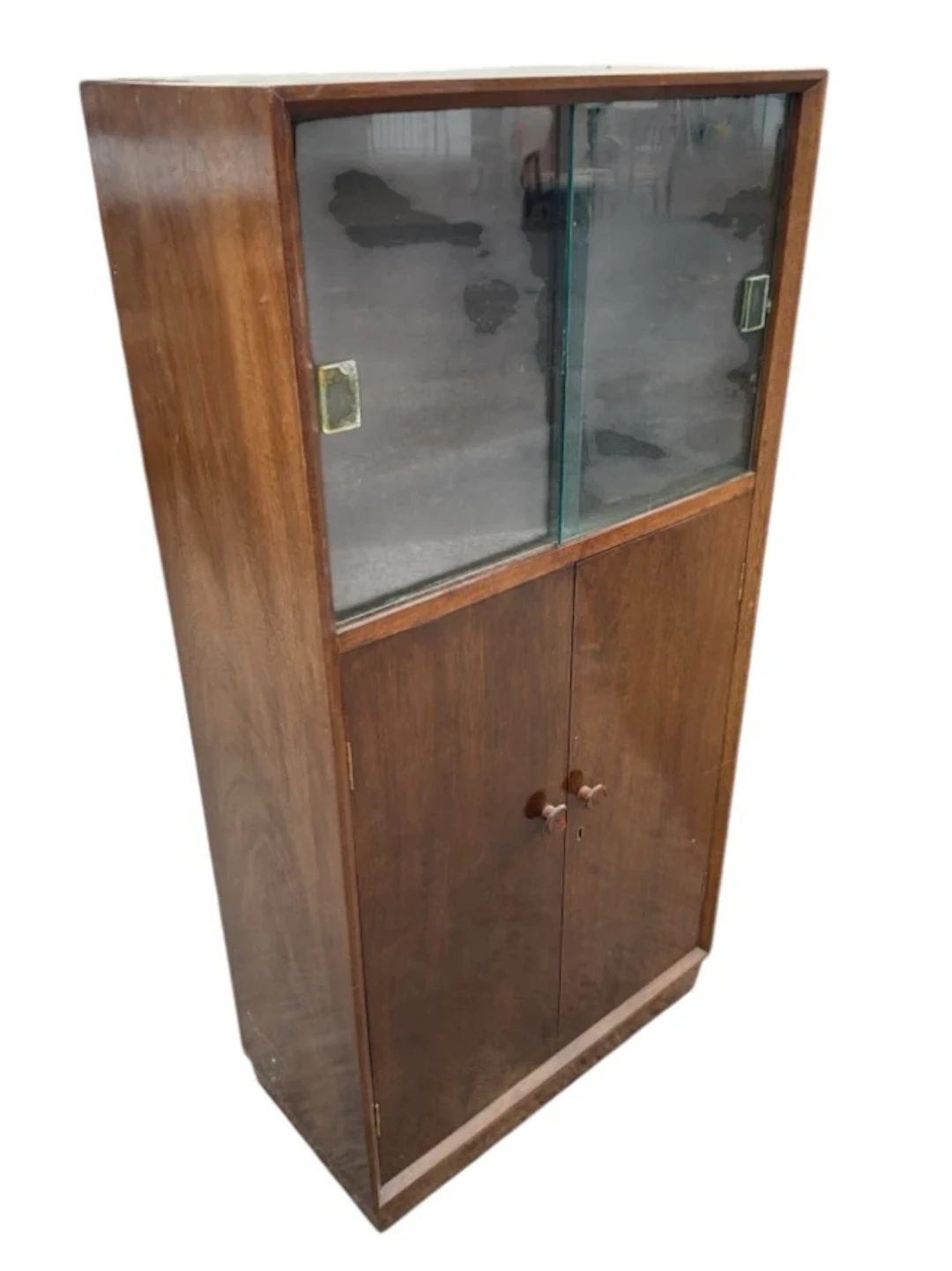 A mid-century mahogany cabinet having sliding glass doors above a
